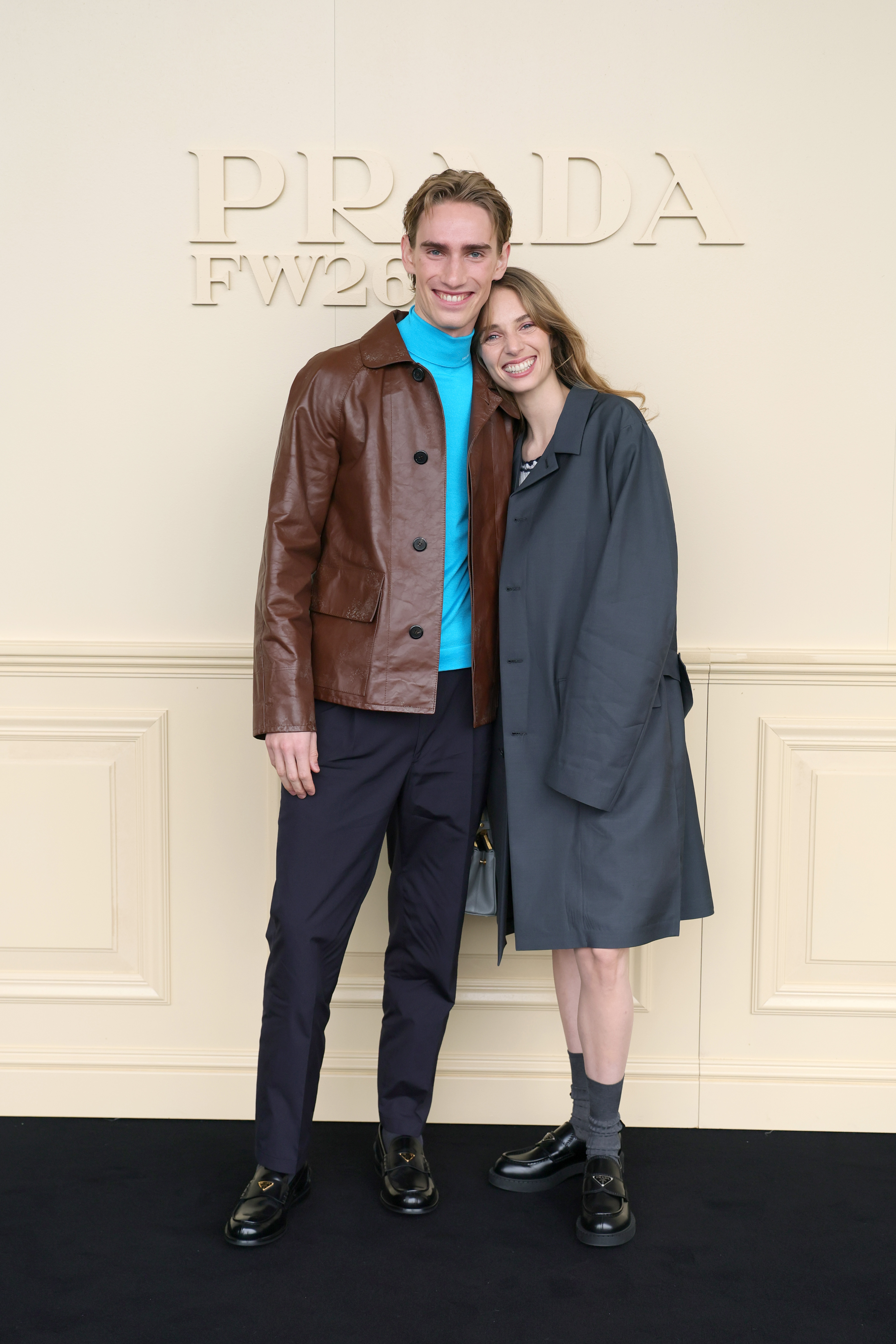 Levon and Maya Hawke smiling for the cameras at the Prada fashion show. | Source: Getty Images