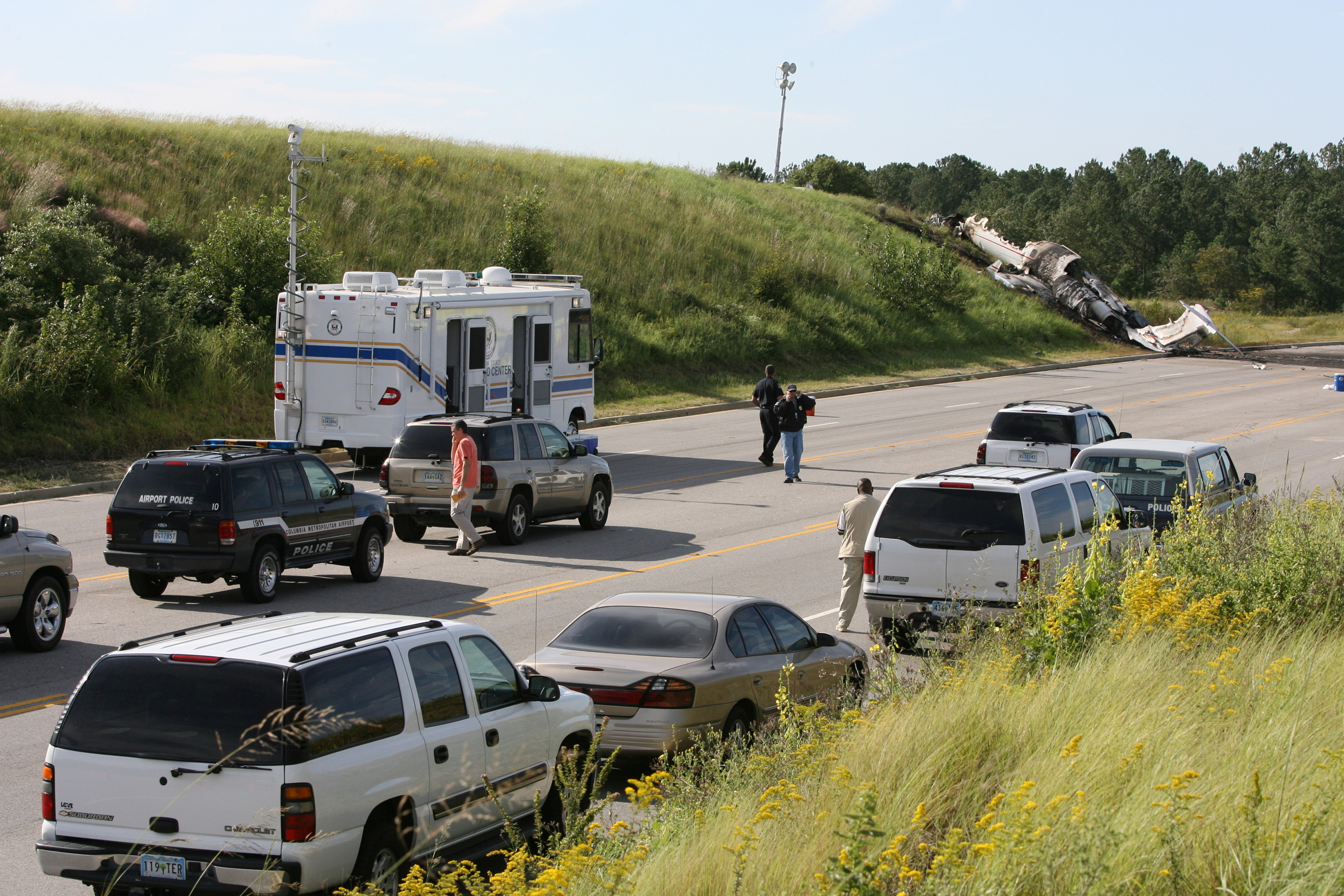 Police vehicles and other official units surrounded the area where the destroyed private jet came to rest following its failed takeoff in West Columbia, South Carolina, on September 20, 2008. | Source: Getty Images