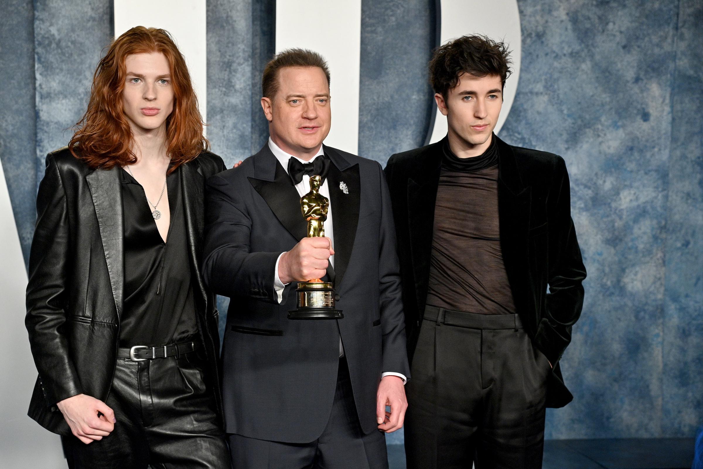 Brendan Fraser was joined by his sons, Holden and Leland Fraser, at the 2023 Vanity Fair Oscar Party at the Wallis Annenberg Center for the Performing Arts in Beverly Hills, California. Still holding the Oscar he had won earlier that evening, the actor posed between his children, who wore contrasting all-black looks. Leland paired his long red hair with a leather suit and satin shirt as the family celebrated Brendan's Best Actor victory on March 12.