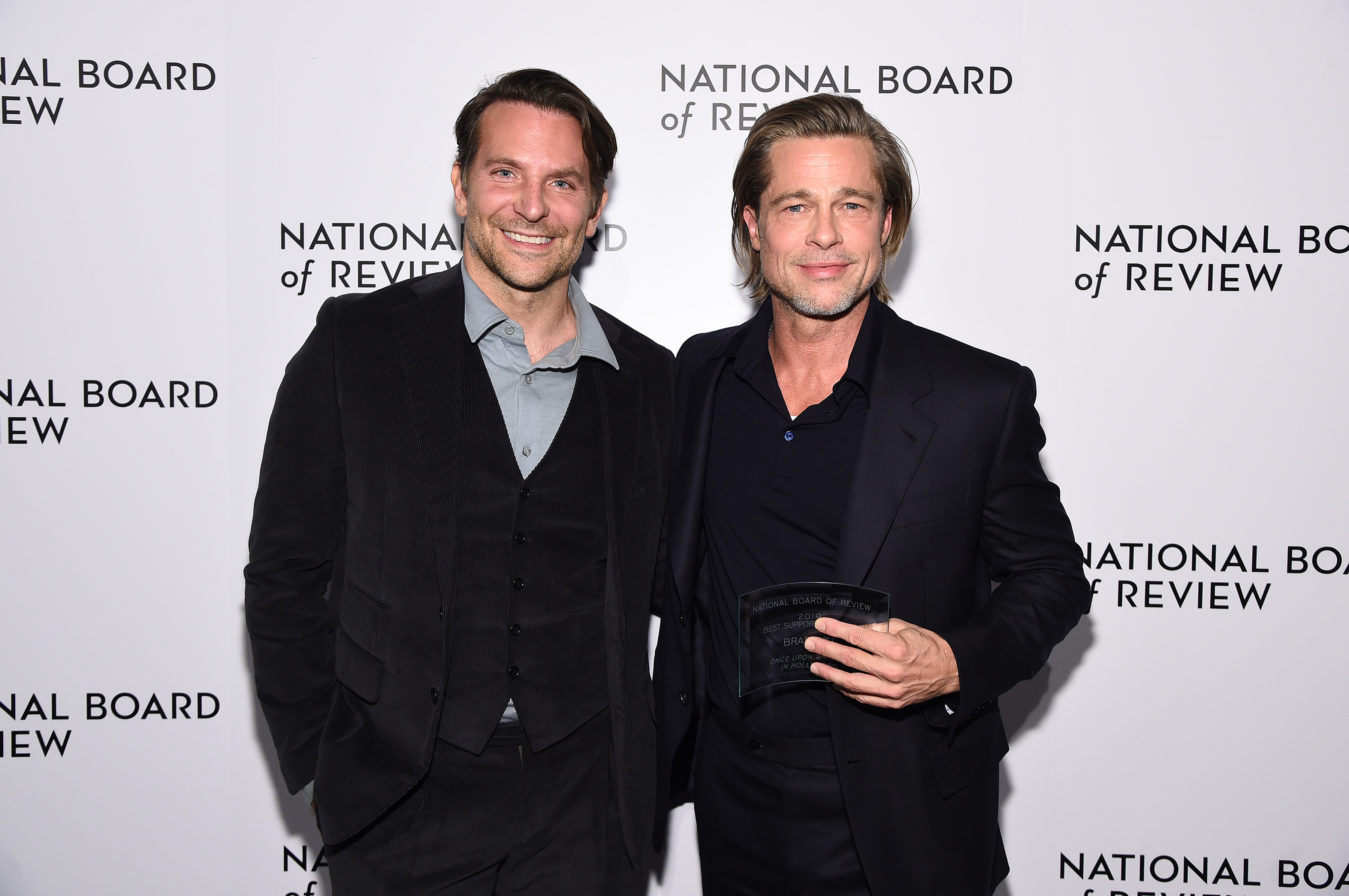 Cooper, now 44, displayed a smooth complexion despite his age with only subtle hints of fine lines around his mouth thanks to his wide smile. He wore his brown hair slicked back off his face while standing next to Brad Pitt, who held an award at The National Board of Review Annual Awards Gala at Cipriani 42nd Street on January 8, 2020, in New York City.