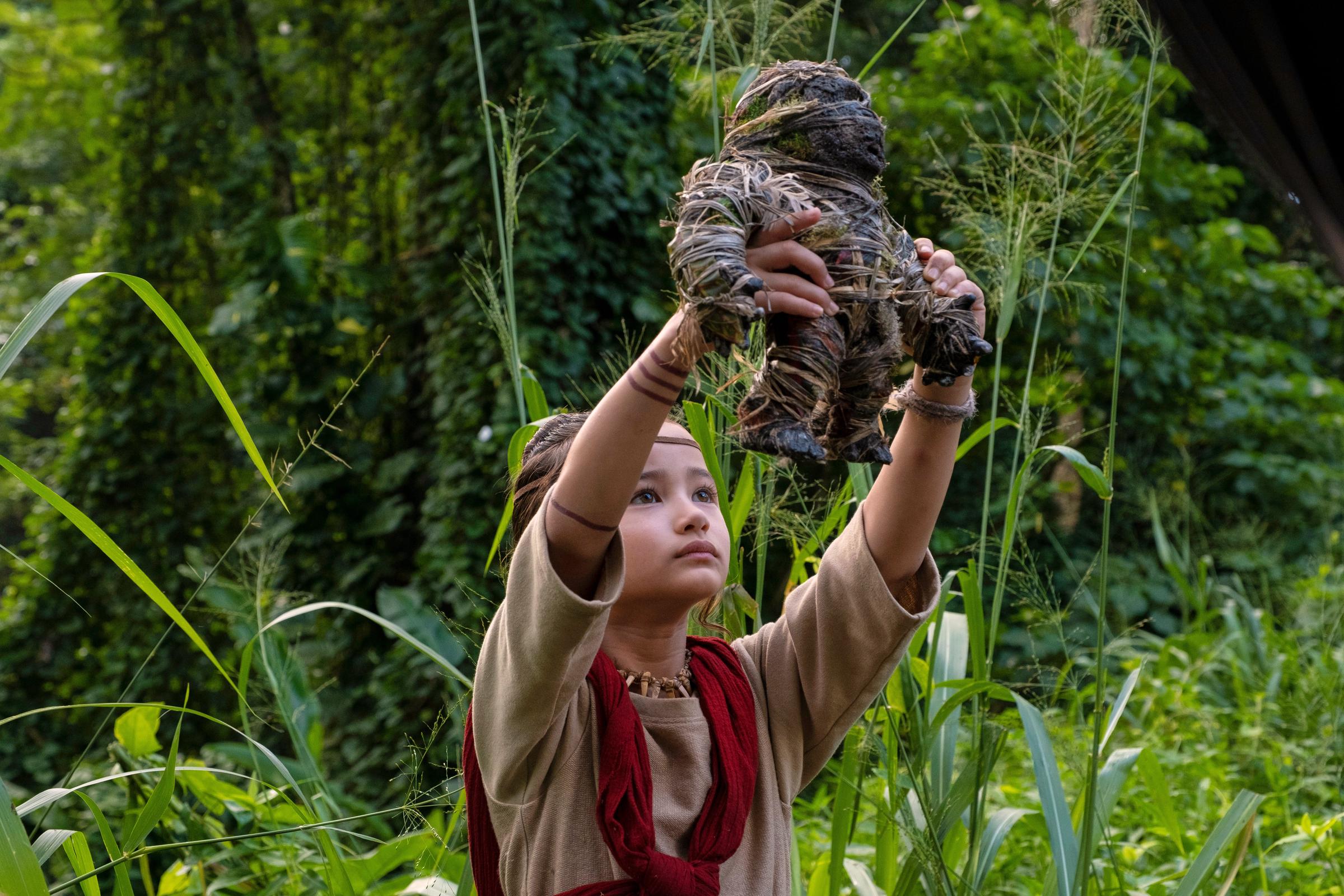 Kaylee Hottle holding up a handcrafted doll of Kong as Jia in "Godzilla vs. Kong," the breakout role that brought authentic American Sign Language representation to a major Hollywood franchise. | Source: Getty Images
