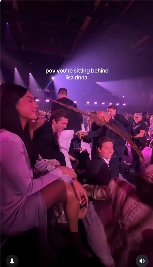 Lisa Rinna’s long feathered headpiece extended over nearby seats during the Victoria’s Secret Fashion Show, as captured in a video shared by Kate Bartlett, who joked about the unexpected encounter with the accessory. | Source: Instagram/katebartlett