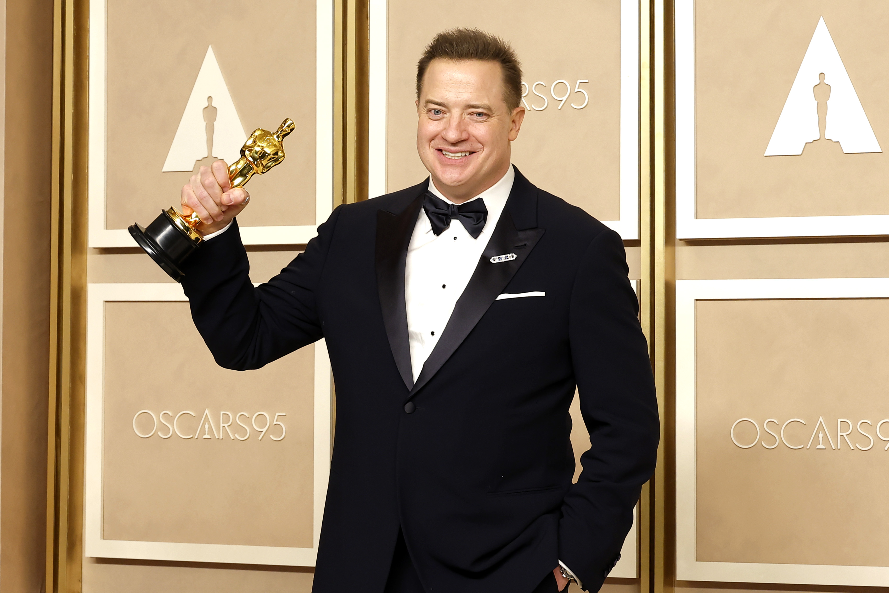 Brendan Fraser proudly holding his first Academy Award for Best Actor in 2023, a triumph that came after nearly seven years of surgeries and recovery from injuries sustained throughout his career. | Source: Getty Images