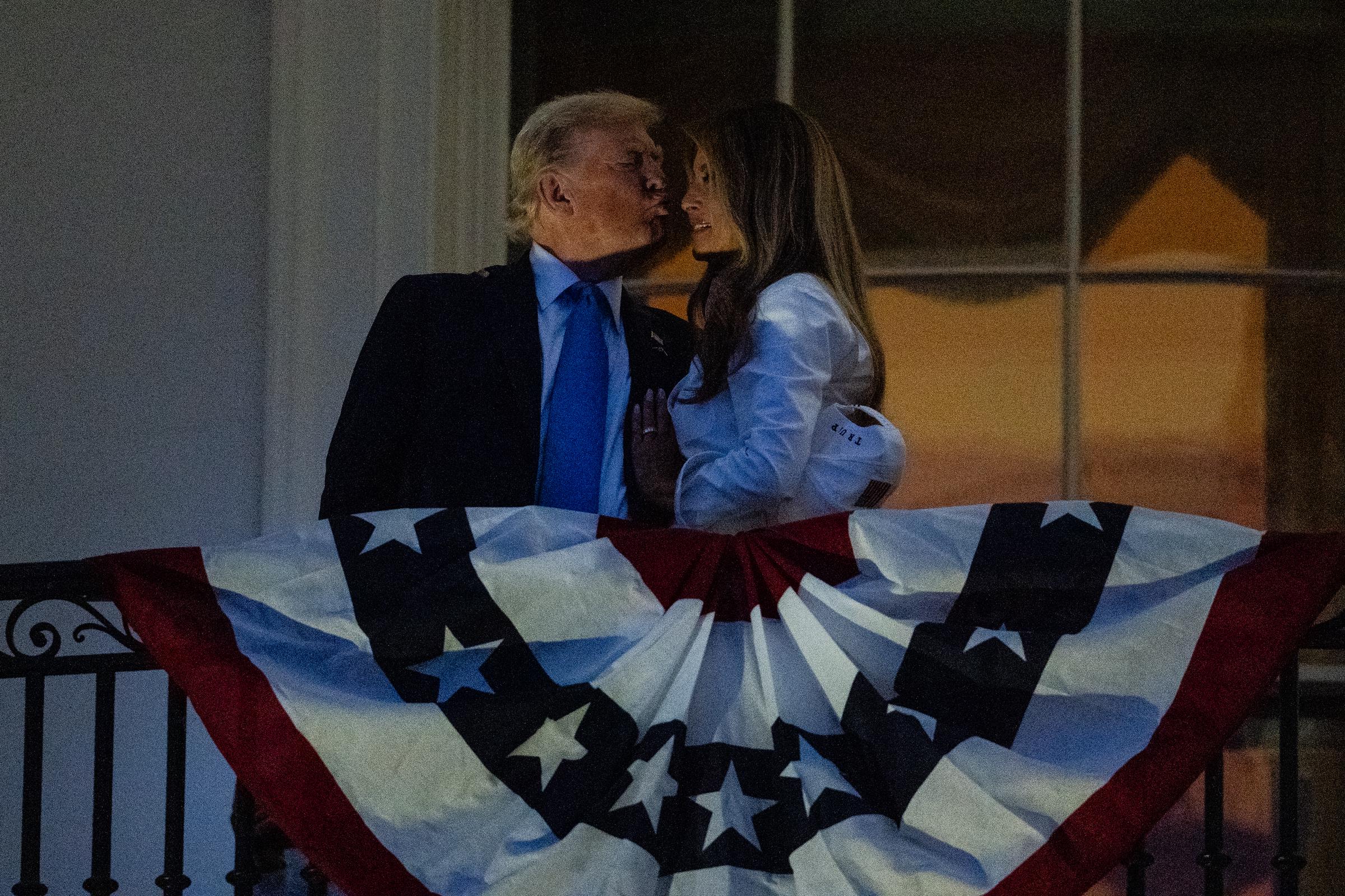 President Donald Trump and First Lady Melania Trump share a kiss as they watch fireworks during a Fourth of July celebration at the White House on July 4, 2025 in Washington, DC. | Source: Getty Images