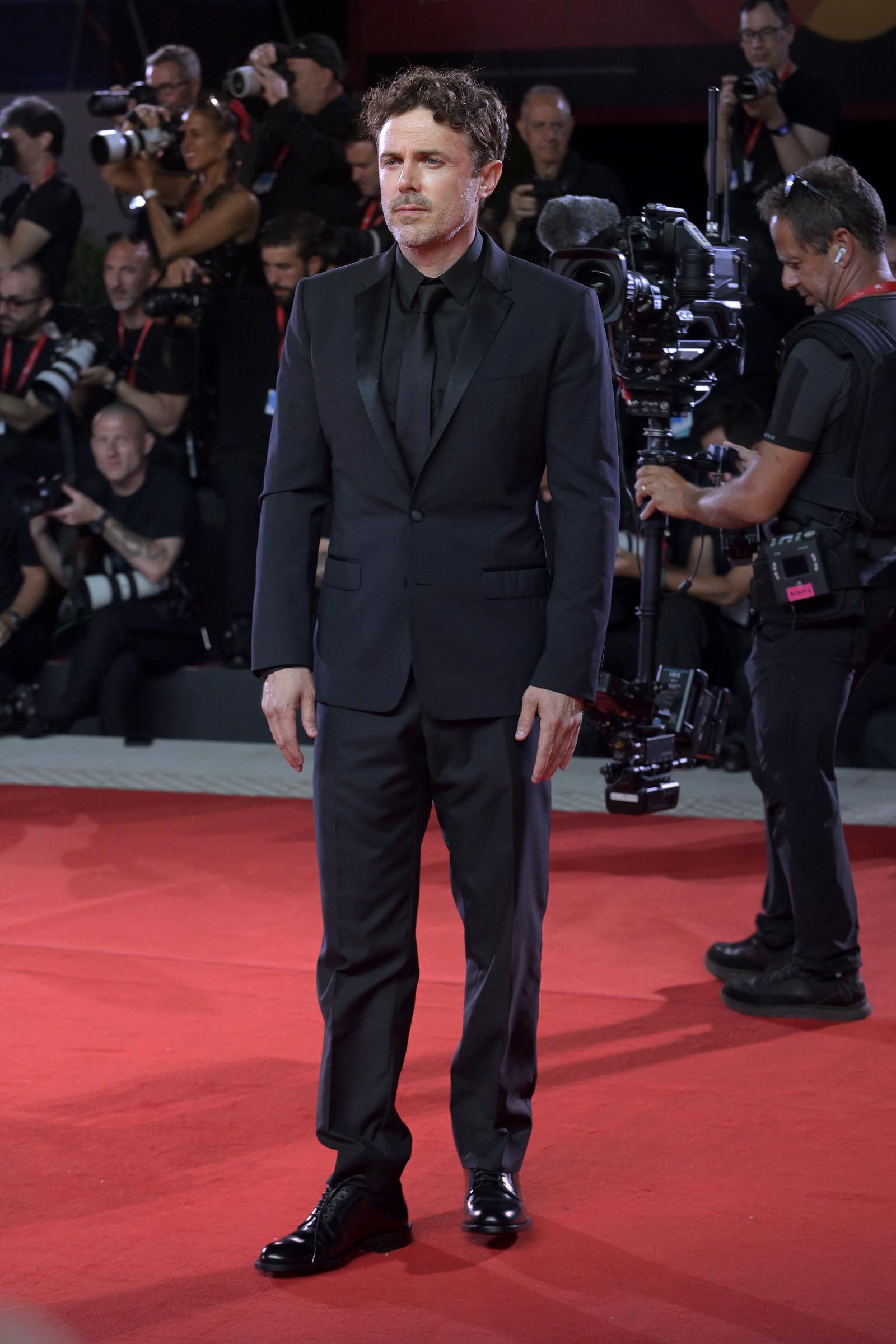 Casey Affleck grounded his sleek all-black formalwear with sharply pressed, straight-leg trousers falling over polished black leather lace-up boots at the "Company" red carpet during the 83rd Venice International Film Festival on September 8, 2026. | Source: Getty Images