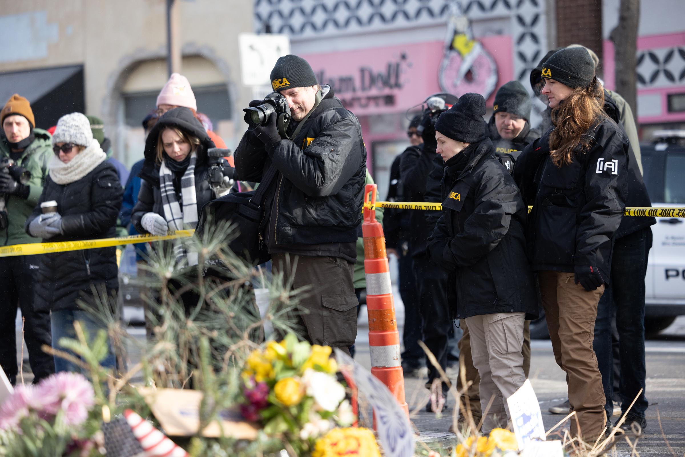 Bureau of Criminal Apprehension police officers survey the scene near a makeshift memorial in the area where Alex Pretti was shot a day earlier by federal immigration agents on January 25, 2026, in Minneapolis, Minnesota | Source: Getty Images