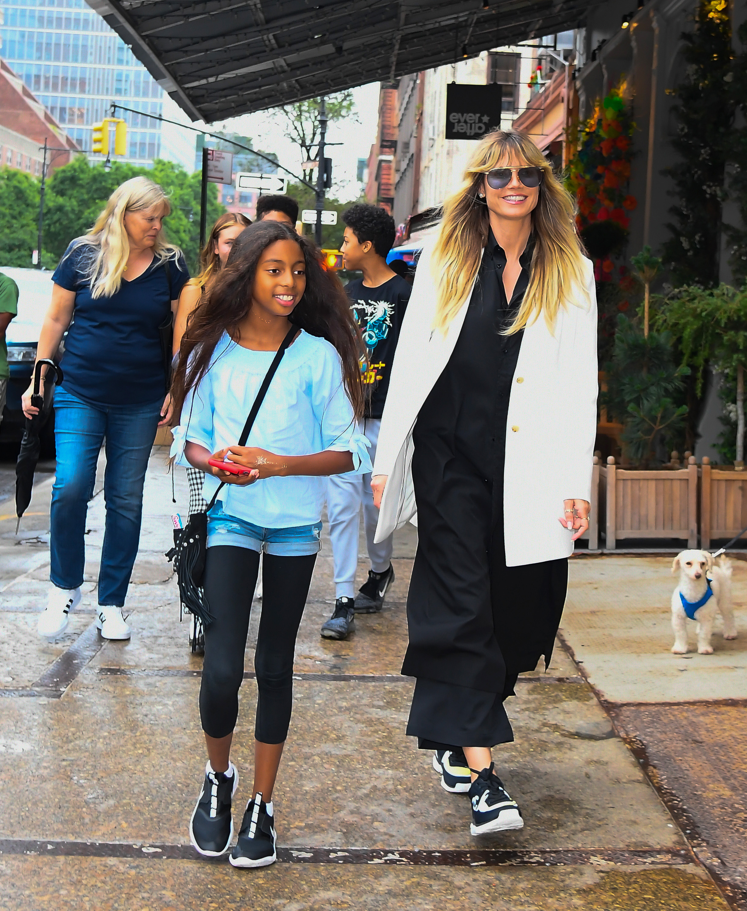 Lou Samuel smiles while walking with her siblings and Heidi Klum in New York City on June 19, 2019 | Source: Getty Images