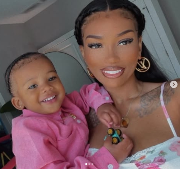 Tyreek Jr. beams alongside his mother, Camille Valmon, as she holds him close for a smiling mother-and-son photo. Wearing a pink shirt while Valmon poses in a floral top and gold statement earrings, the youngster appears relaxed in his mother's arms. The image was shared in a post dated May 12, 2025. | Source: Instagram/tyreekhilljr_