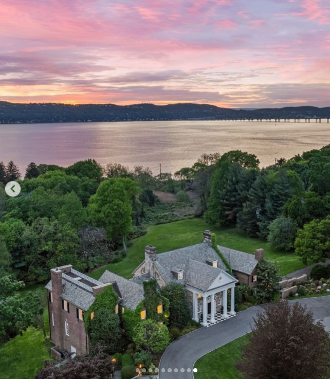 From above, Longmeadow's position along the Hudson River becomes the defining feature of the estate. The mansion sits amid expansive greenery as the river stretches across the horizon, showing the setting behind some of the property's most dramatic views. | Source: Instagram/rogerperrygroup