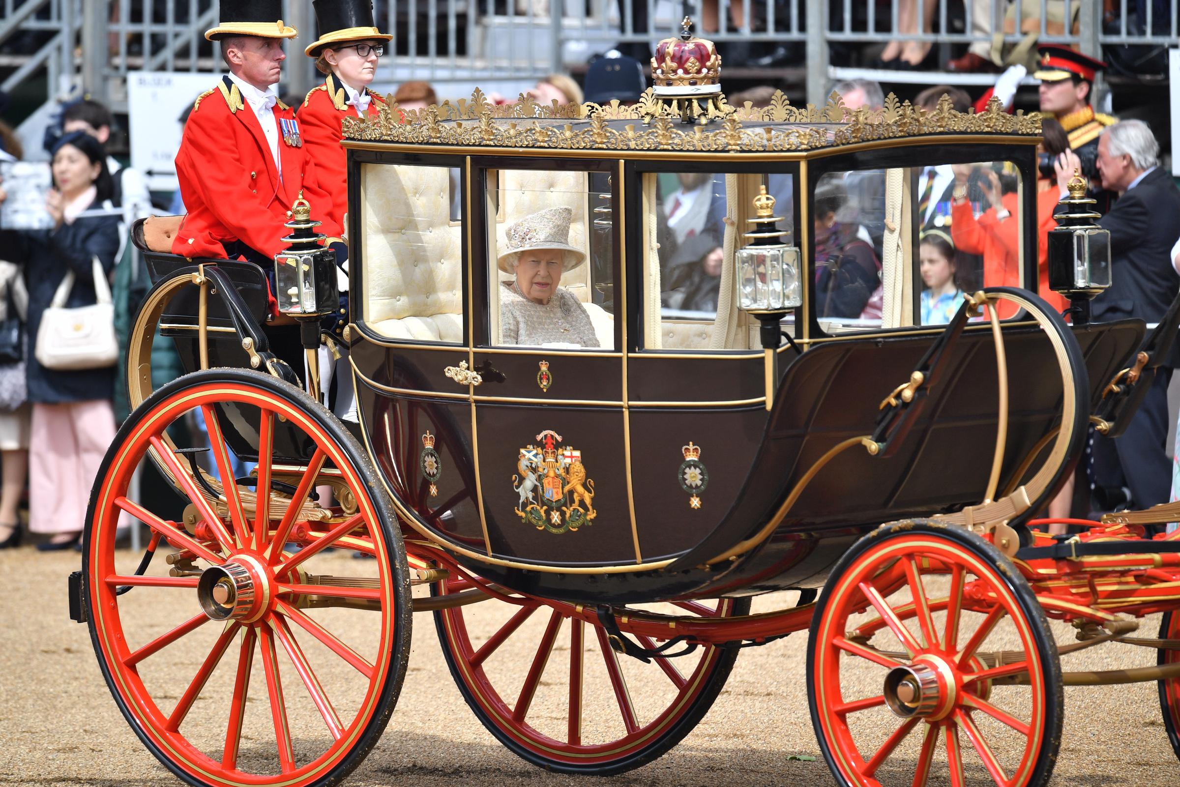Queen Elizabeth II is seen riding in a gilded horse-drawn coach during Trooping the Colour at Horse Guards Parade, marking her official birthday in London on June 8, 2019 | Source: Getty Images