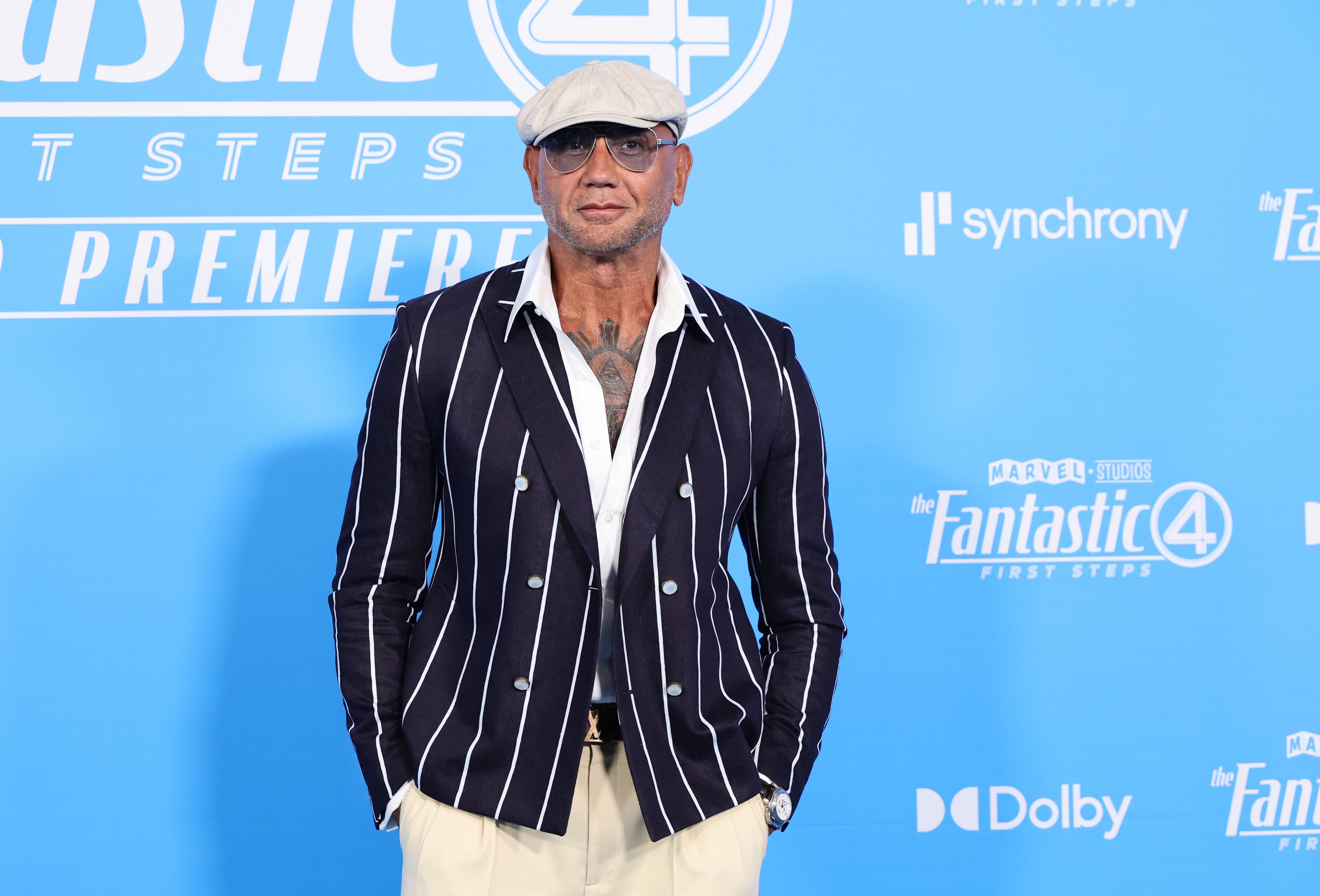 Several months later, Dave Bautista's slimmer build remained evident when he attended Marvel Studios' "The Fantastic Four: First Steps" at the Dorothy Chandler Pavilion in Los Angeles, California, on July 21, 2025. The actor paired cream trousers with a fitted, striped double-breasted jacket, an open-collar white shirt, tinted glasses, and a flat cap. His appearance offered another look at the leaner physique he had maintained after losing 75 pounds, which he previously said left him feeling better and looking better on camera alongside other actors.