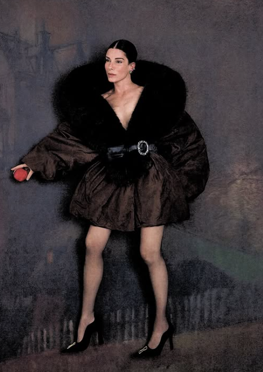 Sandra Bullock channeled old-Hollywood glamour in a sculptural black outfit while holding an apple during her Interview Magazine photo shoot. | Source: Instagram/sandrabullock