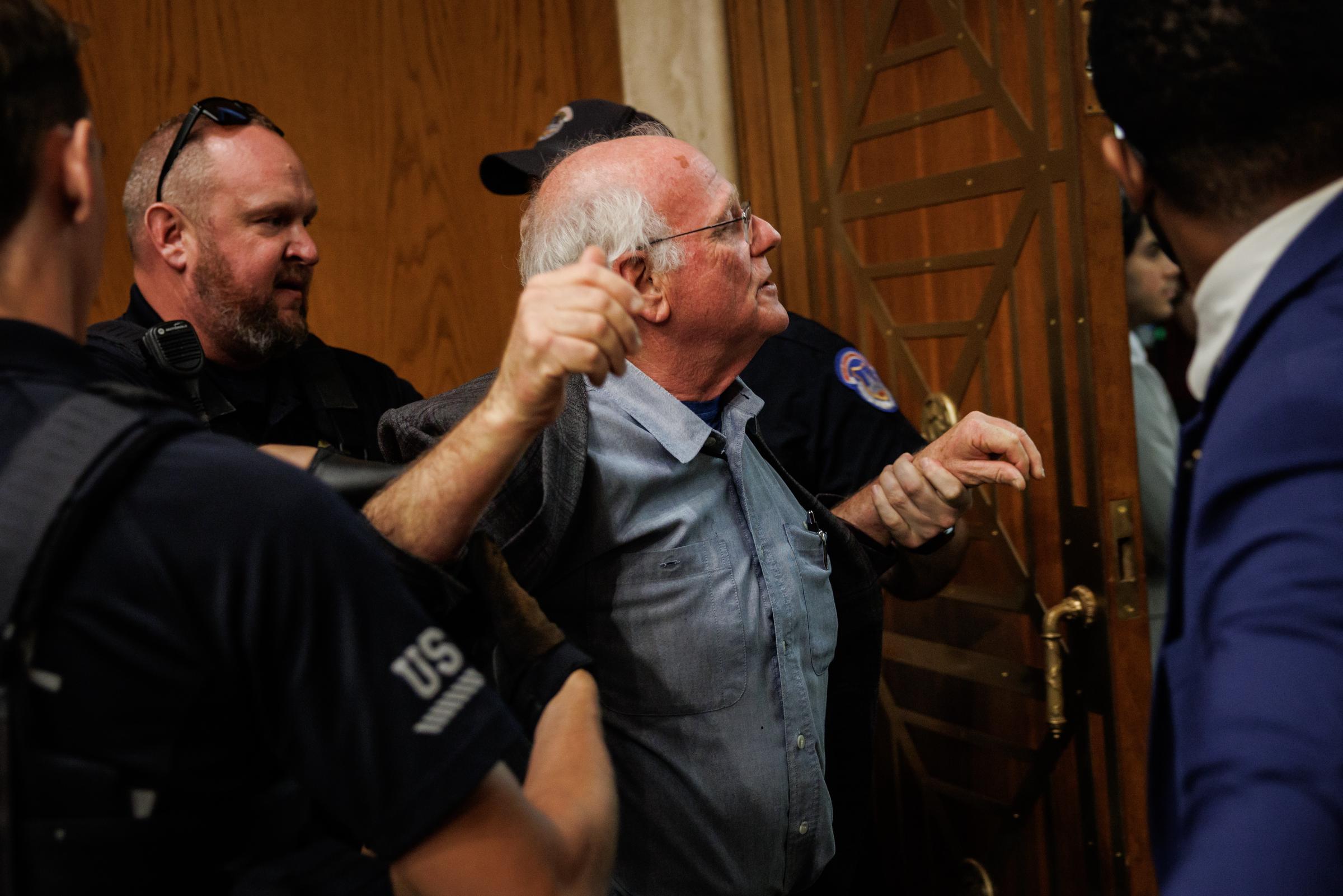 Ben Cohen is detained by the U.S. Capitol Police for disrupting proceedings during a hearing with Secretary of Health and Human Services Robert F. Kennedy Jr. on May 14, 2025, in Washington, D.C. | Source: Getty Images