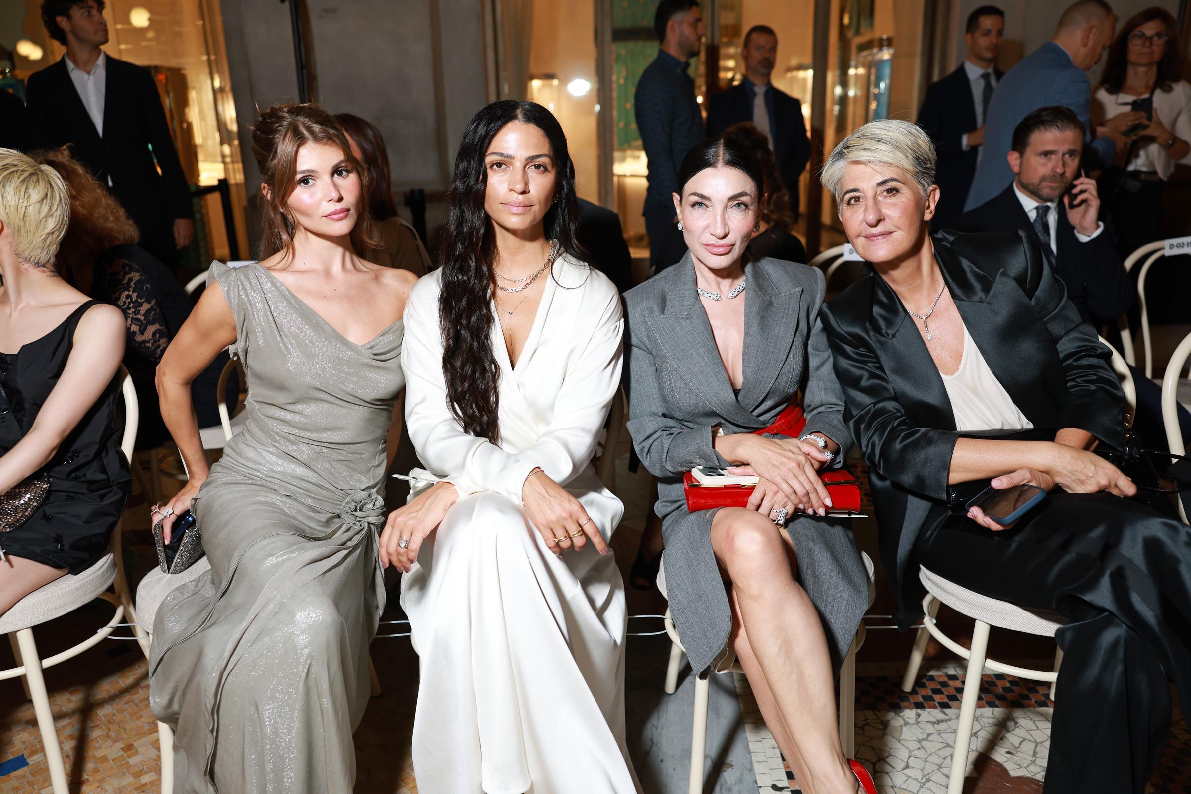 Alves sits with Olivia Jade and Elisabetta Franchi, facing the camera as her layered necklaces and plunging wrap neckline take center stage. | Source: Getty Images