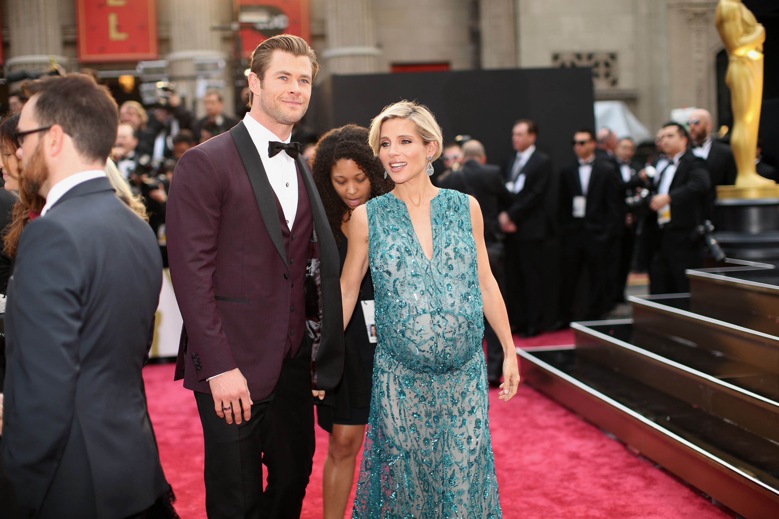 A heavily pregnant Elsa Pataky walks the red carpet with Chris Hemsworth at the Oscars, held at Hollywood & Highland Center on March 2, 2014, in Hollywood, California. Elsa wore a sleeveless, teal beaded gown, while Chris opted for a burgundy tuxedo with black lapels.