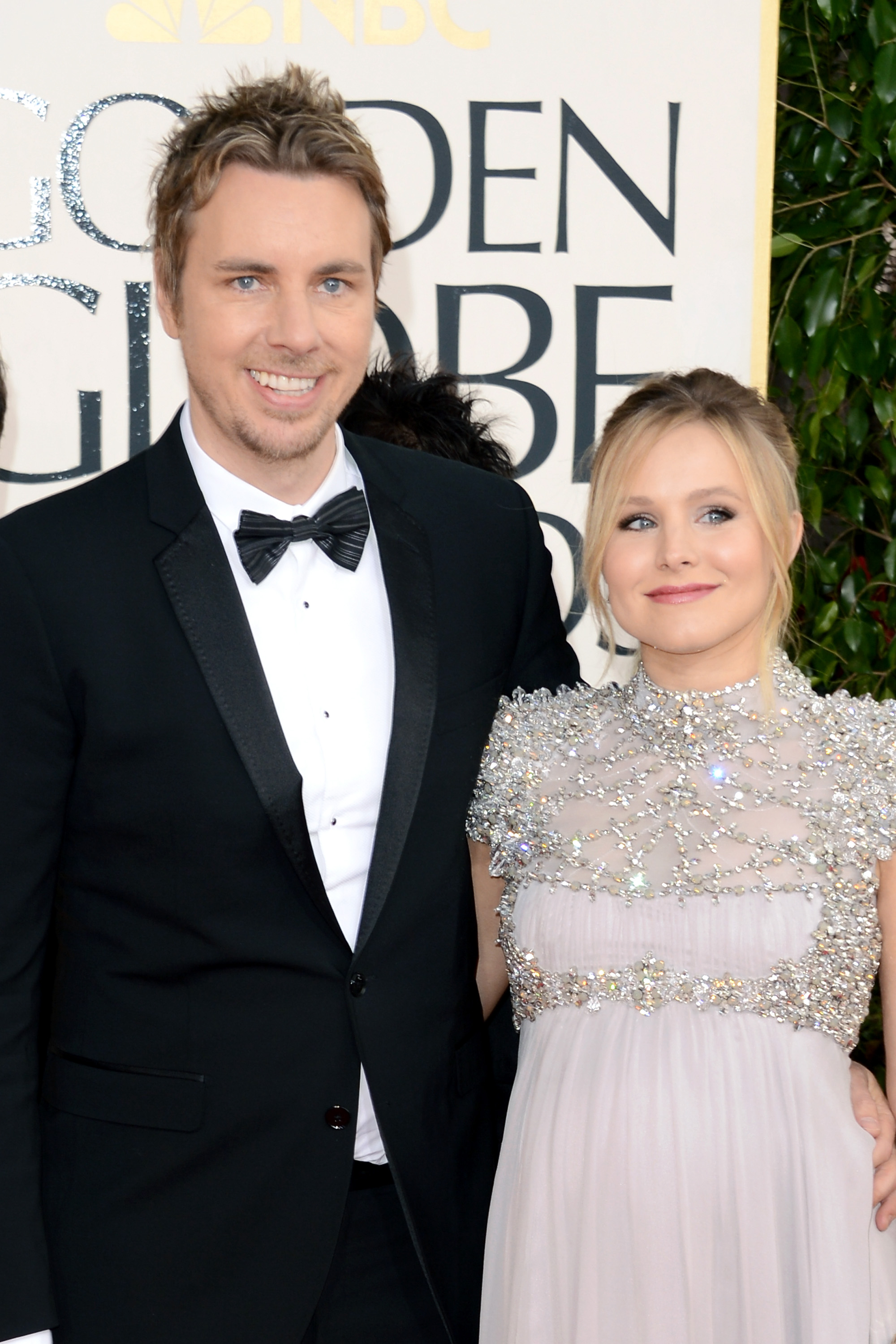 Dax Shepard and Kristen Bell shine on the red carpet at the 70th Annual Golden Globe Awards. Shepard wears a sharp black tuxedo while Bell stuns in a sparkling embellished gown.