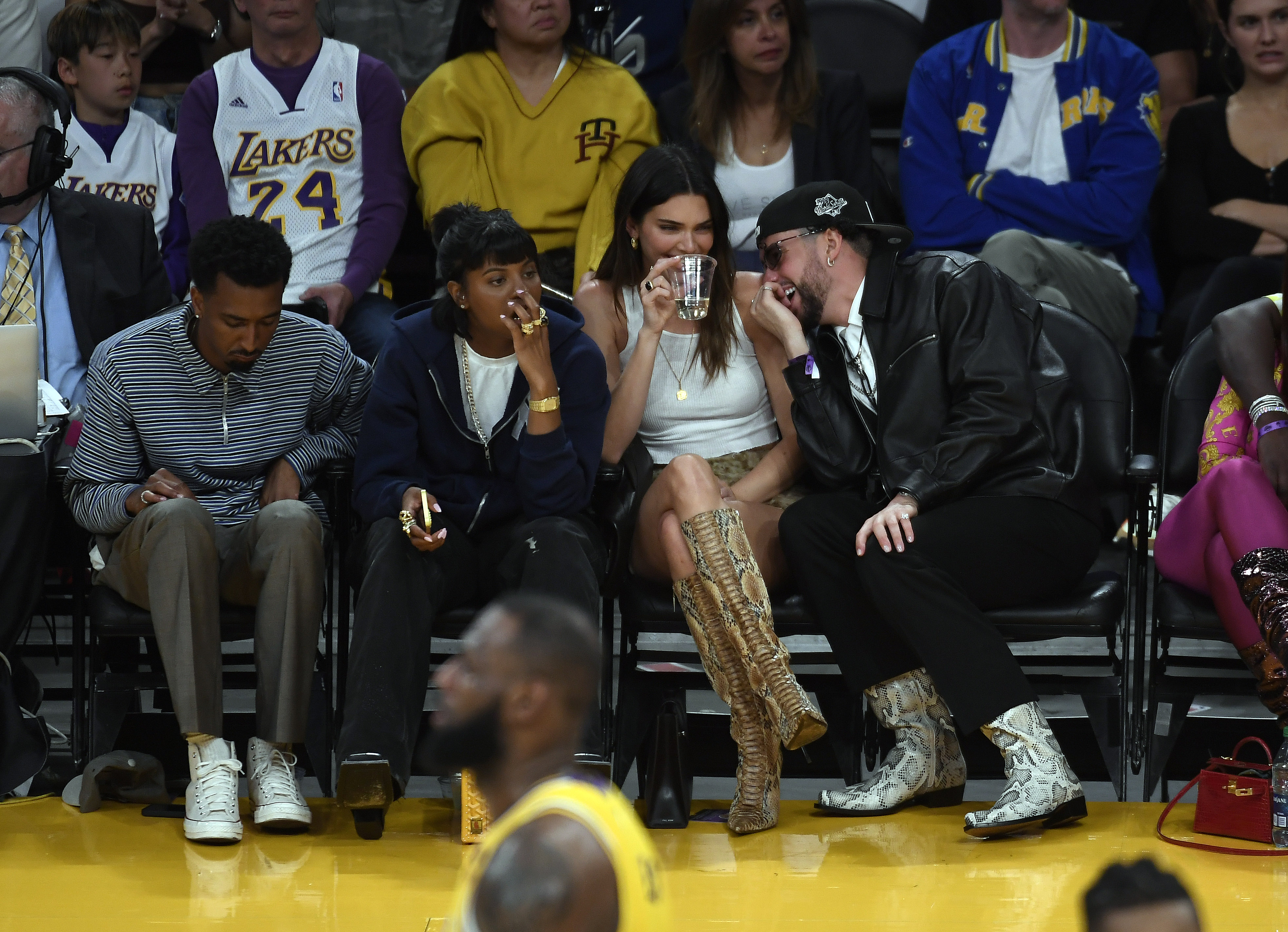 Kendall Jenner and Bad Bunny sharing a laugh alongside Renell Medrano and Yung Taco at the Western Conference Semifinal Playoff game between the Los Angeles Lakers and Golden State Warriors in Los Angeles, California on May 12, 2023. | Source: Getty Images