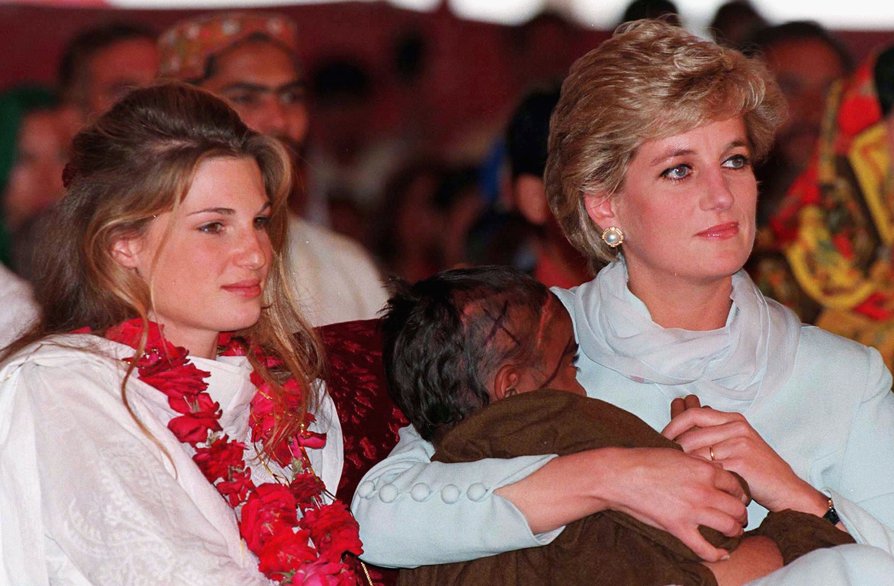 Diana, Princess of Wales, cradles a young cancer patient in her arms beside Jemima Khan during a visit to Shaukat Khanum Hospital on February 22, 1996, in Lahore, Pakistan. | Source: Getty Images