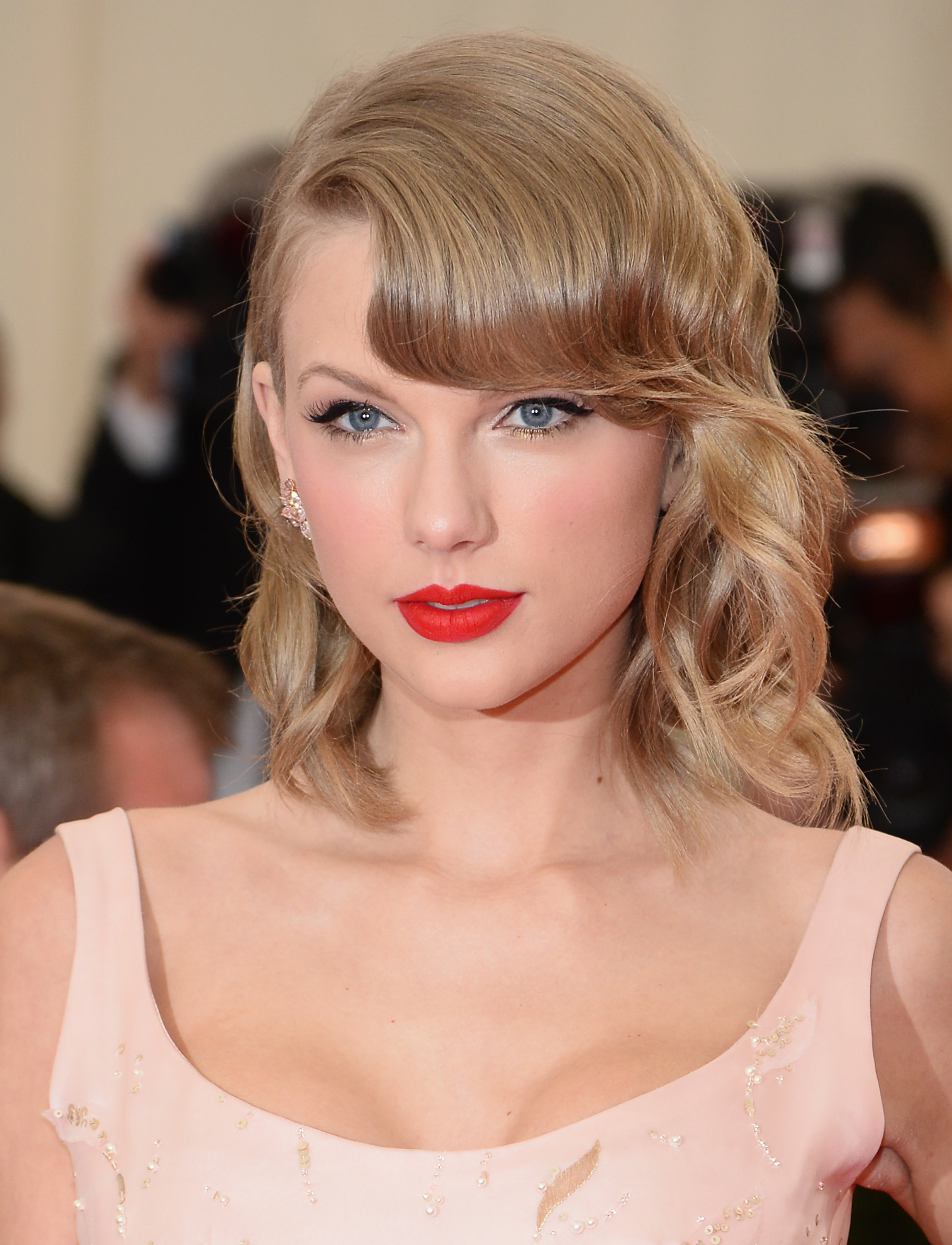 Taylor Swift trades her signature nude lipstick for a bold red, making a striking statement. Her eyebrows also appear more arched as she attends the “Charles James: Beyond Fashion” Costume Institute Gala at the Metropolitan Museum of Art in New York City.