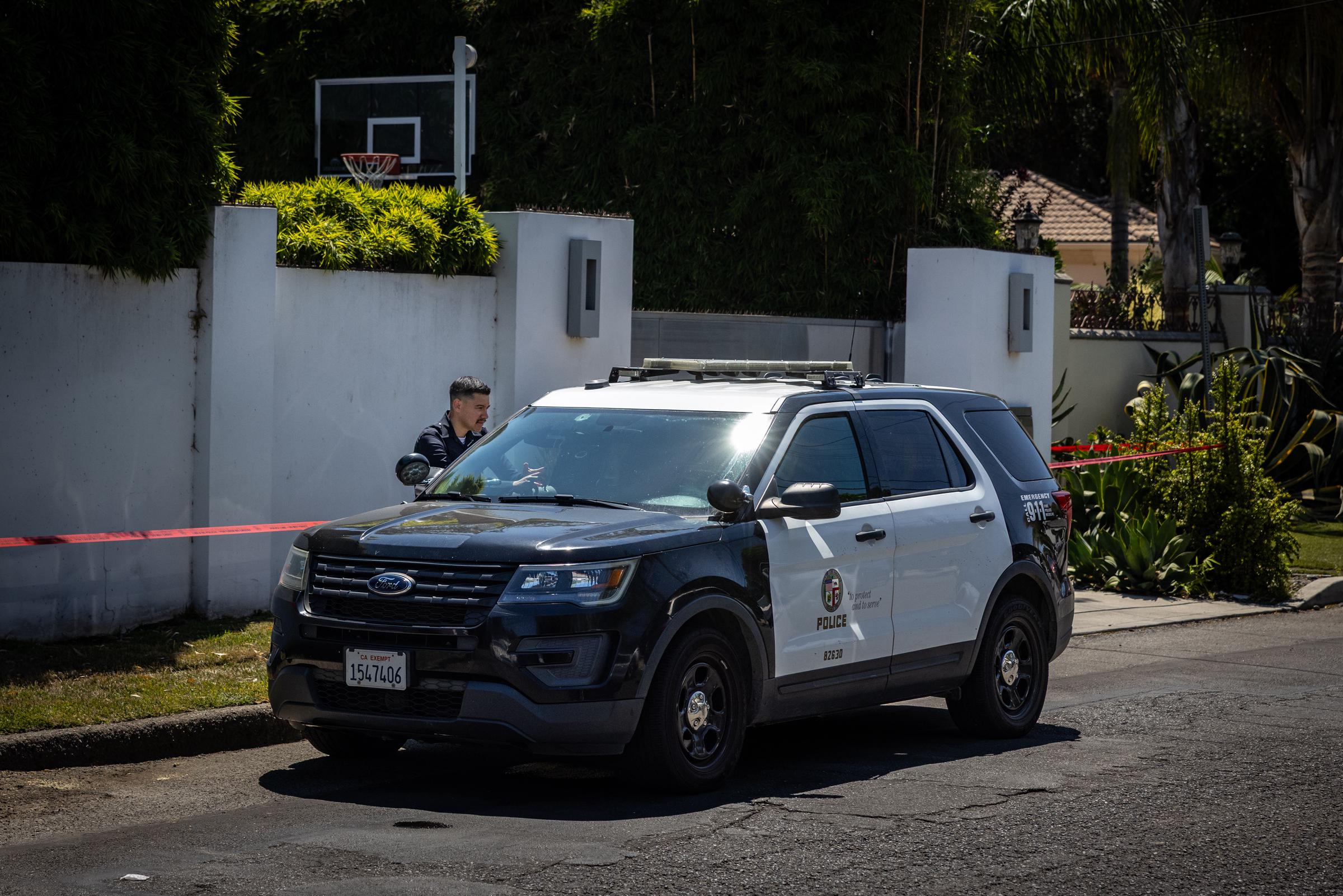 A member of the Los Angeles Police Department outside Robin Kaye and Thomas DeLuca's home on Tuesday, July 15, 2025 in Encino, CA | Source: Getty Images