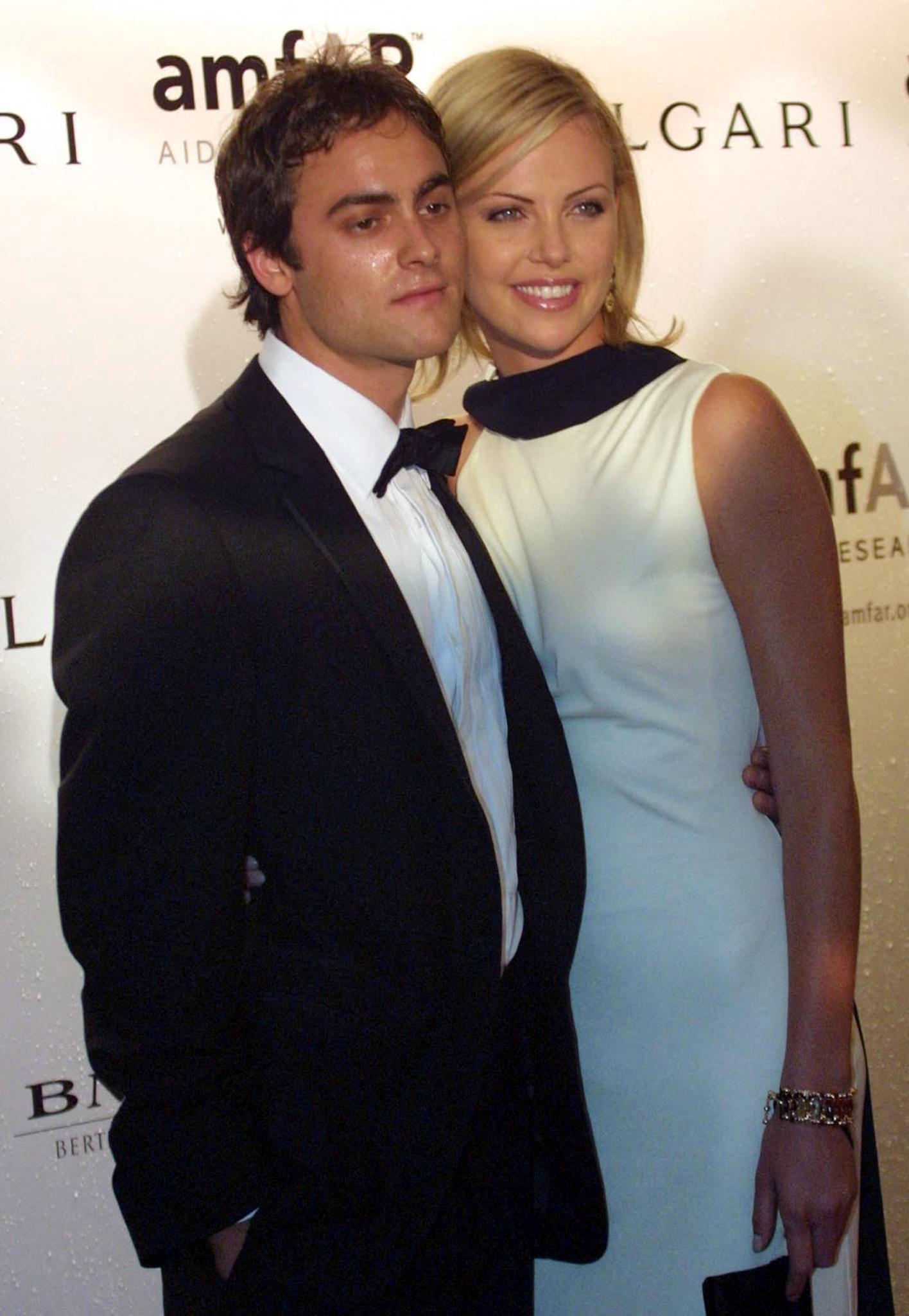 Stuart Townsend accompanied his then-girlfriend, Charlize Theron, to an amfAR dinner held alongside the 58th Venice International Film Festival on August 31, 2001. Townsend wore a black tuxedo as the couple posed together for photographers, while Theron chose a pale sleeveless dress for the occasion, capturing the Irish actor later that year as his career continued beyond the major role he had once prepared to play in "The Lord of the Rings."