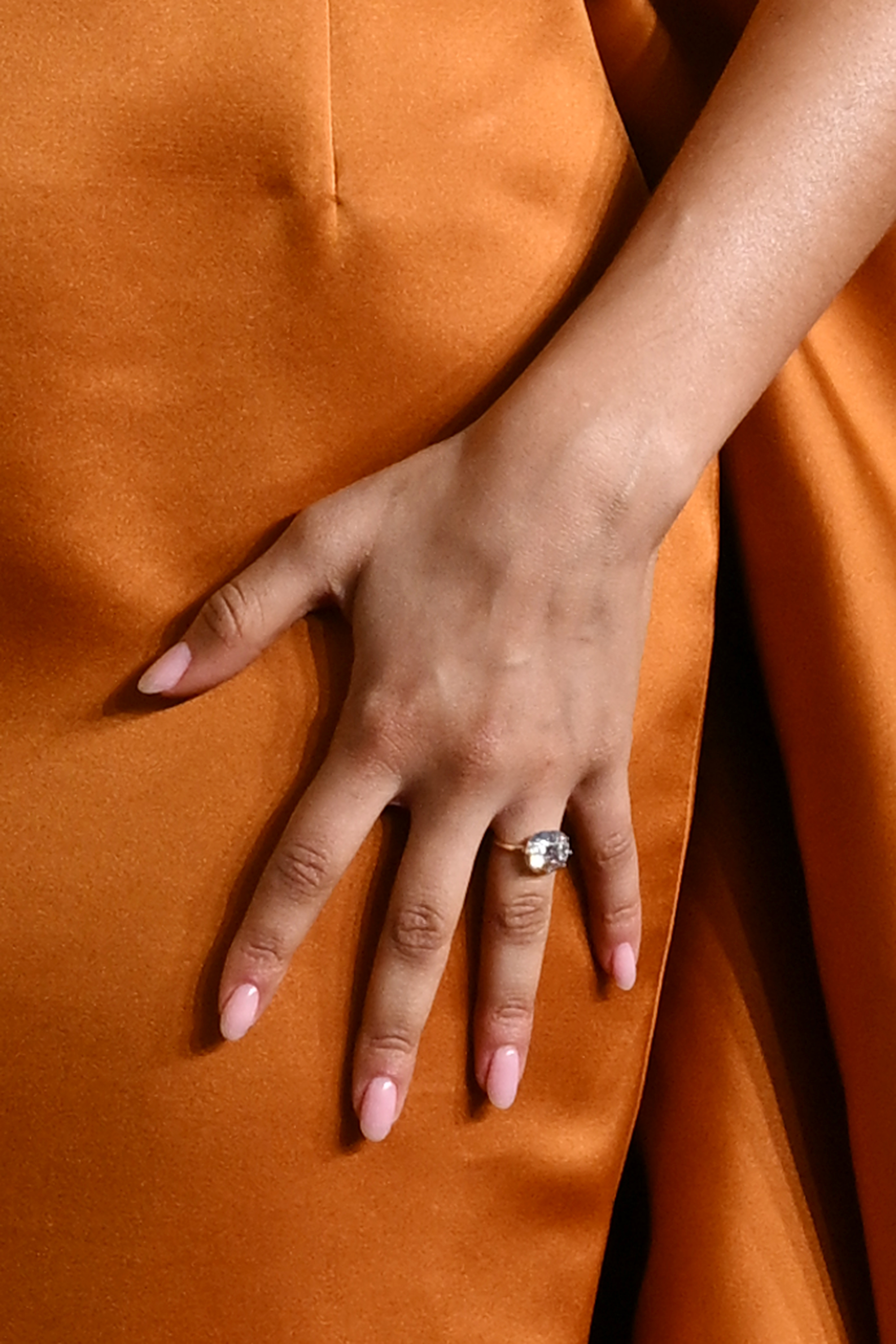 Zendaya rests her hand on her gown, showcasing the prominent oval-cut diamond | Source: Getty Images
