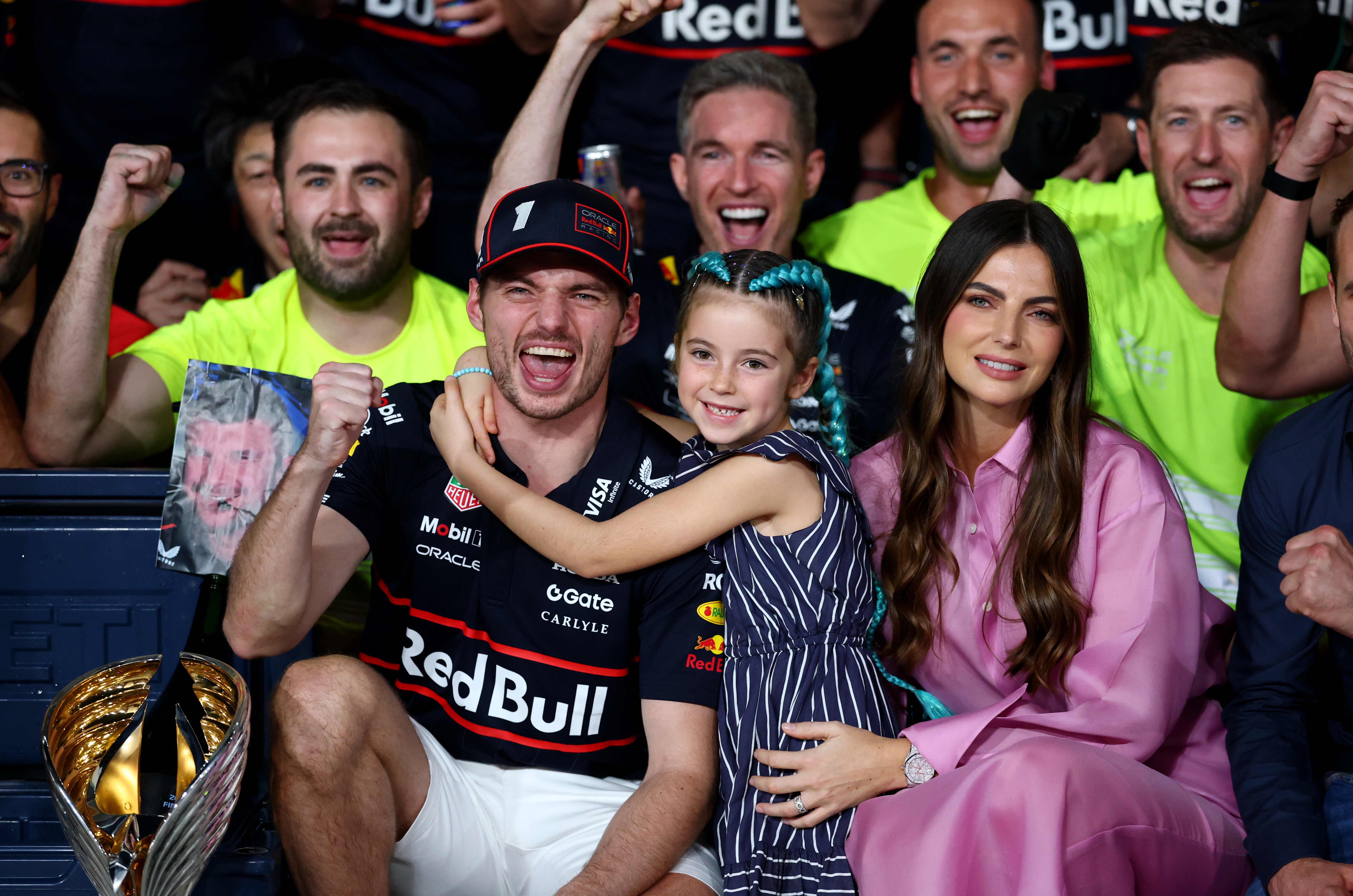 Max Verstappen celebrates with his team, Kelly Piquet, and Penelope Piquet during the Formula One Grand Prix of Abu Dhabi at Yas Marina Circuit in Abu Dhabi, United Arab Emirates, on December 7, 2025, in a heartwarming shot capturing the shared joy of victory with his family and crew.