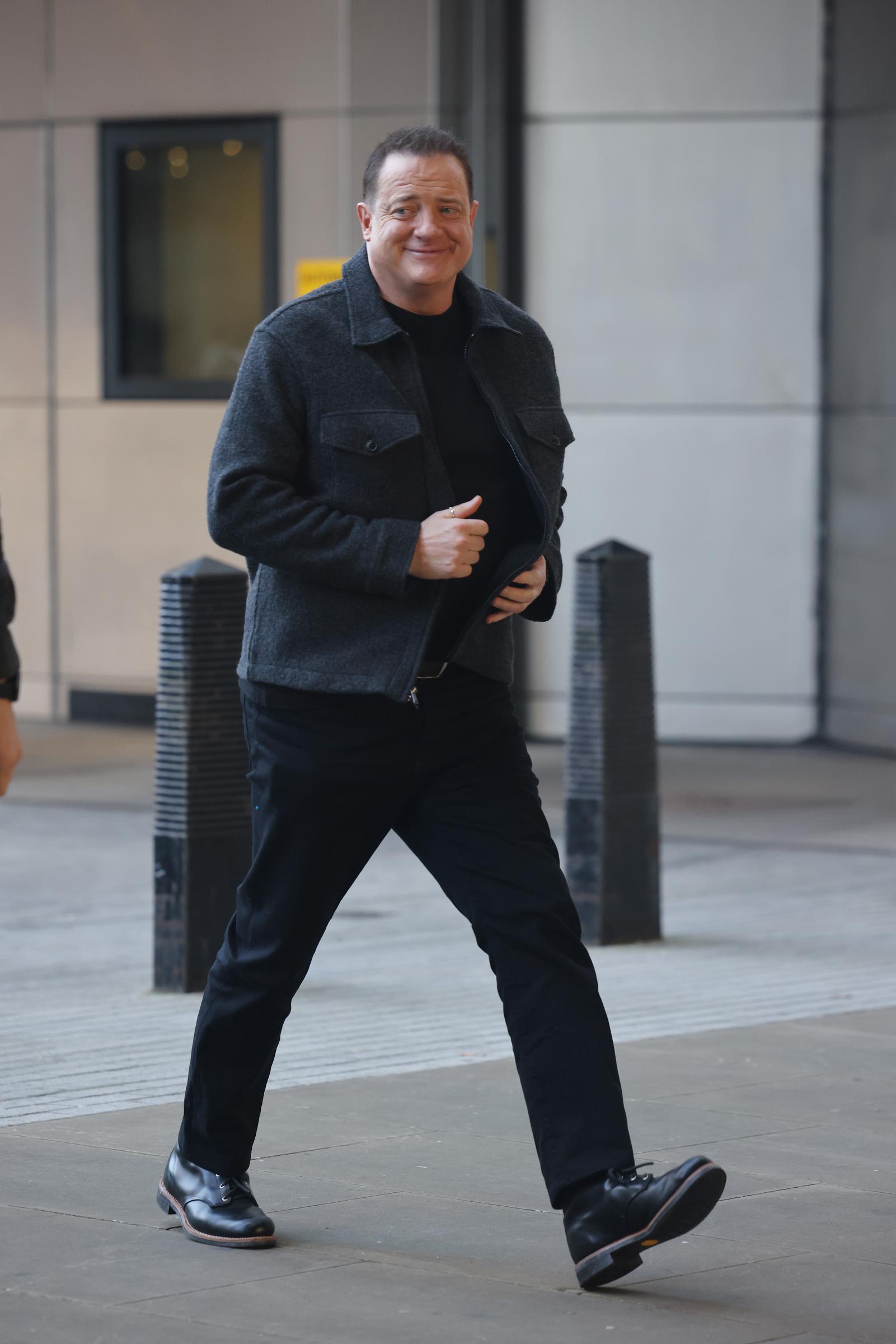 Brendan Fraser steps out with a smile, showing off his noticeably slimmer appearance after years of dramatic physical transformations for his film roles. | Source: Getty Images.