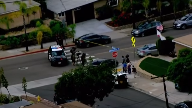 Police vehicles and investigators gather near the San Carlos home where Amy and David Voight and their 13-year-old daughter, Mya, were found dead. | Source: YouTube/FOX 5 San Diego
