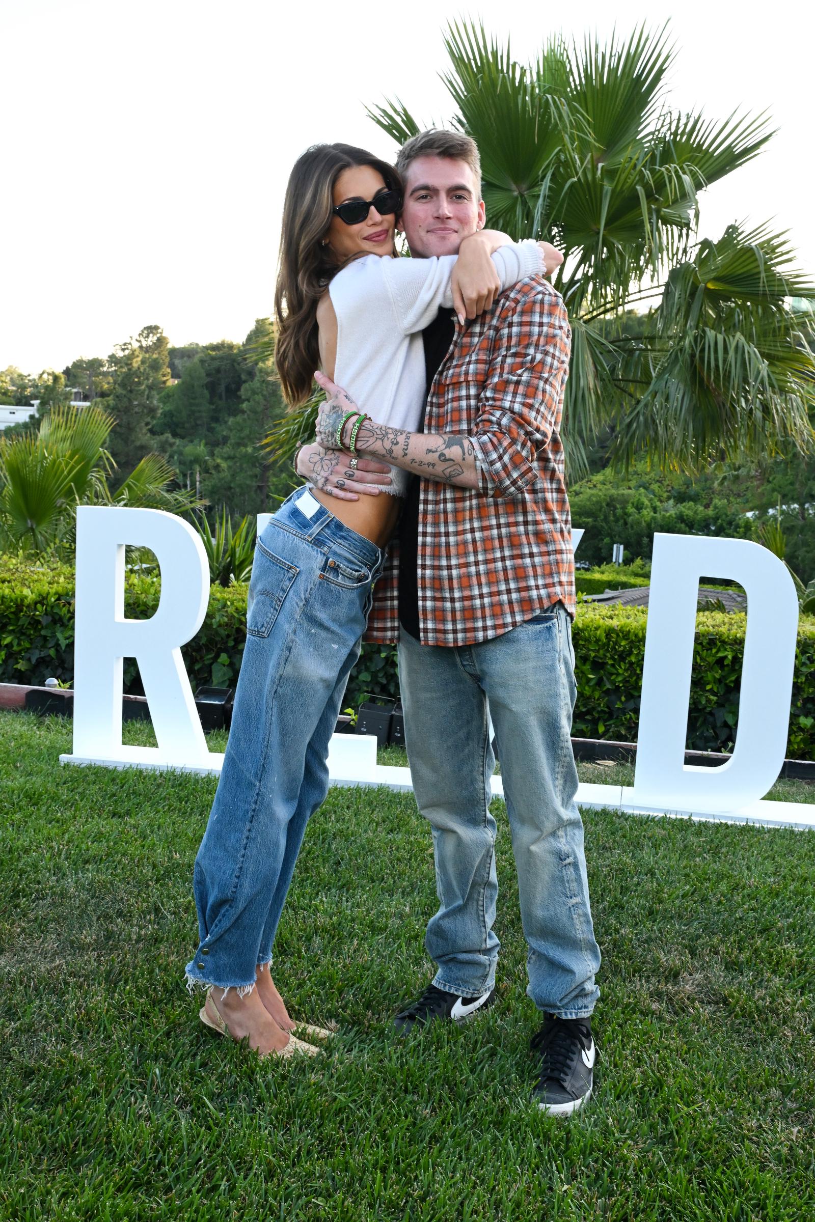 Presley Gerber stepped out to support his sister Kaia at the launch of her RE/DONE "Short/Cuts" collection on May 20, 2026, in Los Angeles, California, where the duo shared a warm, tight embrace that showed off their close sibling bond. Posing on the lawn in effortless West Coast denim, Kaia stunned in an open-back white knit top while Presley rocked a warm plaid overshirt over a black tee, putting his hand and arm tattoos on display as they celebrated her milestone together.