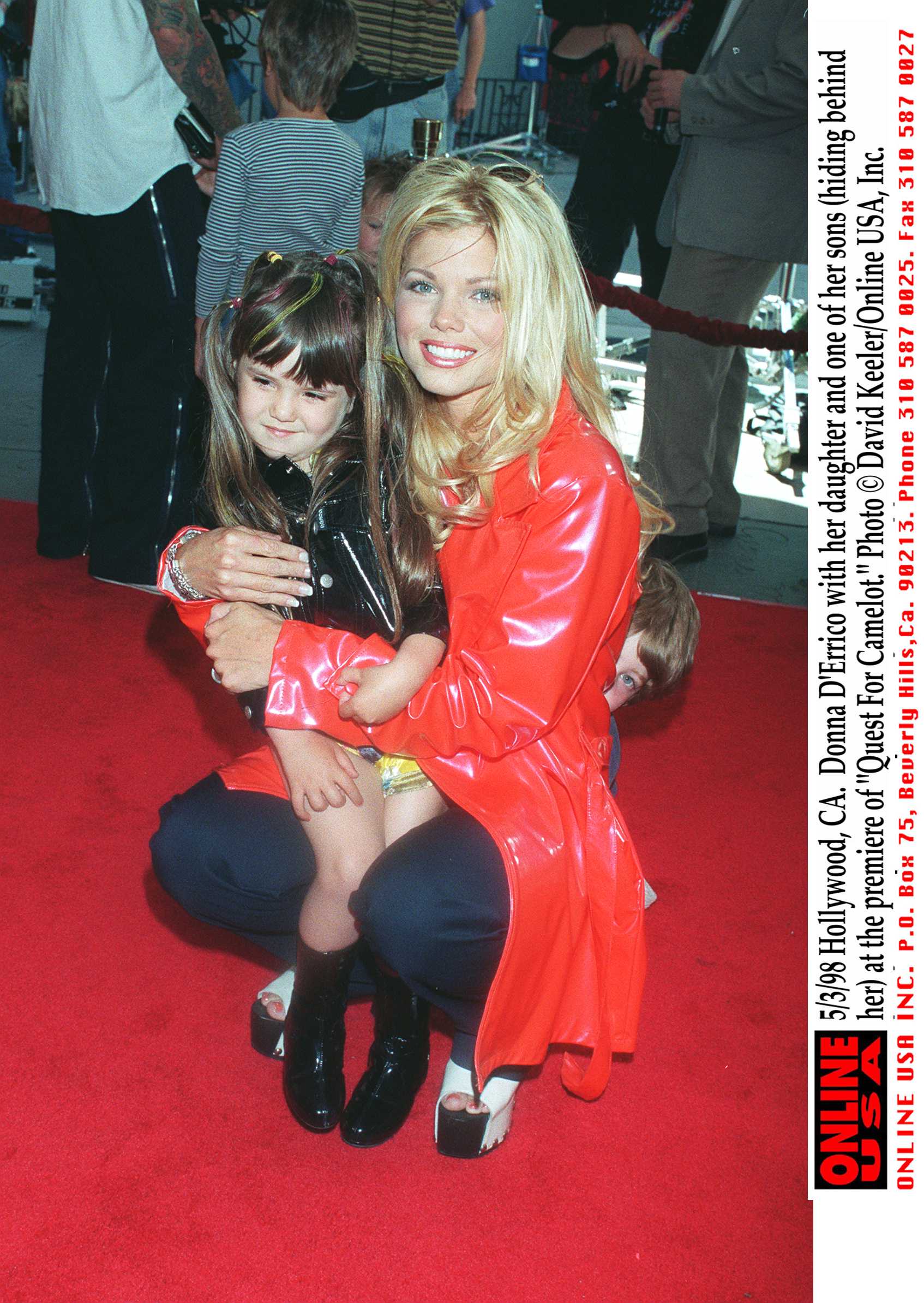 The actress pictured with her daughter and son (hiding behind her) at the premiere of "Quest For Camelot" in 1998 | Source: Getty Images