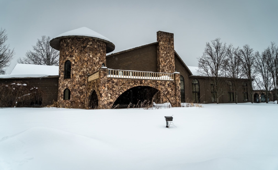 In a Facebook post dated April 7, 2026, snow blankets the grounds surrounding Mike Tyson's sprawling former Ohio residence, where a cylindrical stone tower, broad balcony, and towering chimney dominate the exterior. The imposing architecture hints at the scale of the 25,000-square-foot mansion, which sat on a 60-acre property and once served as Tyson's home while he trained at promoter Don King's nearby boxing camp. | Source: Facebook/Johnny Joo