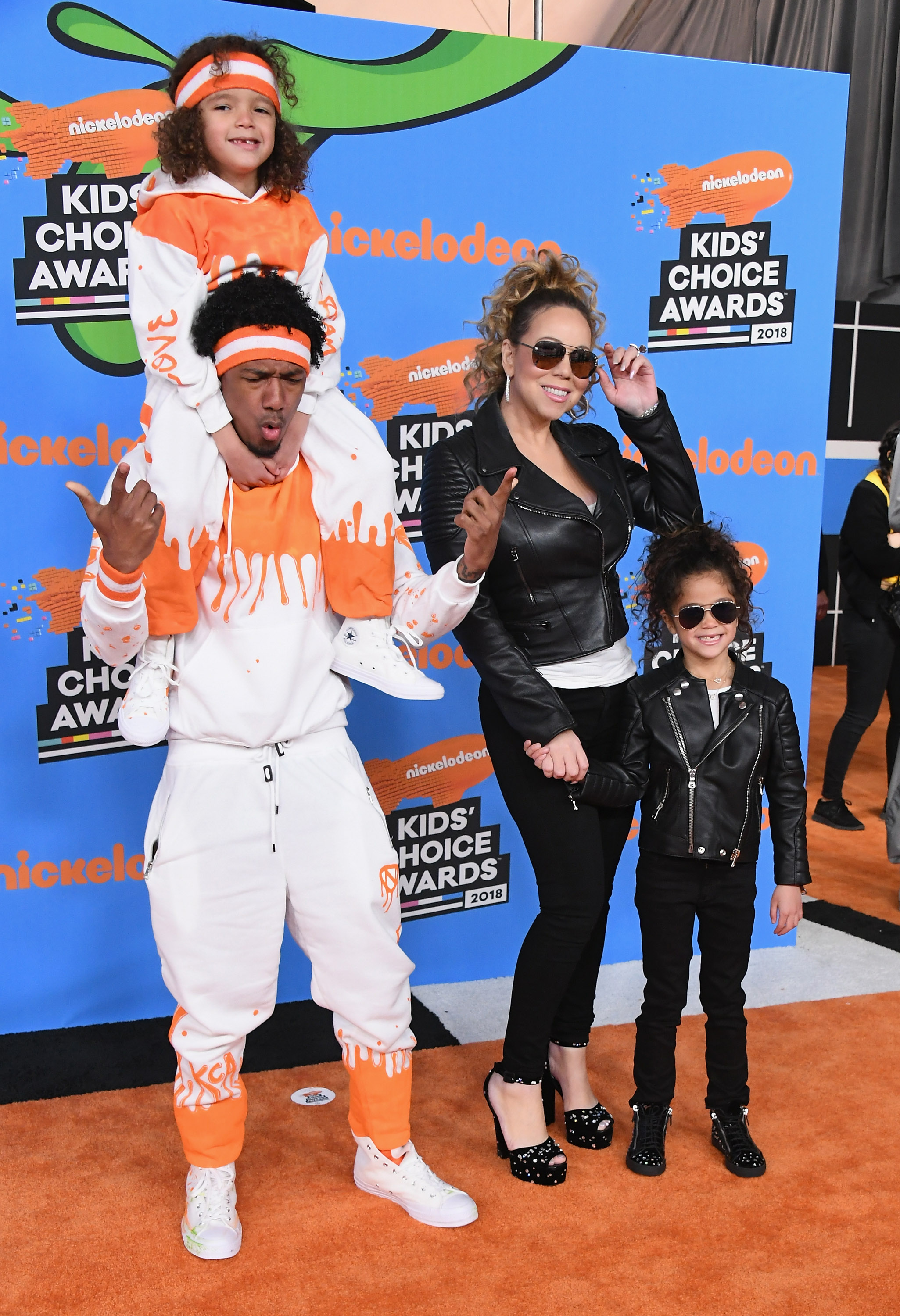 Nick Cannon matched Moroccan's orange-and-white outfit at the 2018 Kids' Choice Awards, while Mariah Carey and Monroe wore coordinating black looks — turning their family appearance into a playful fashion moment. | Source: Getty Images
