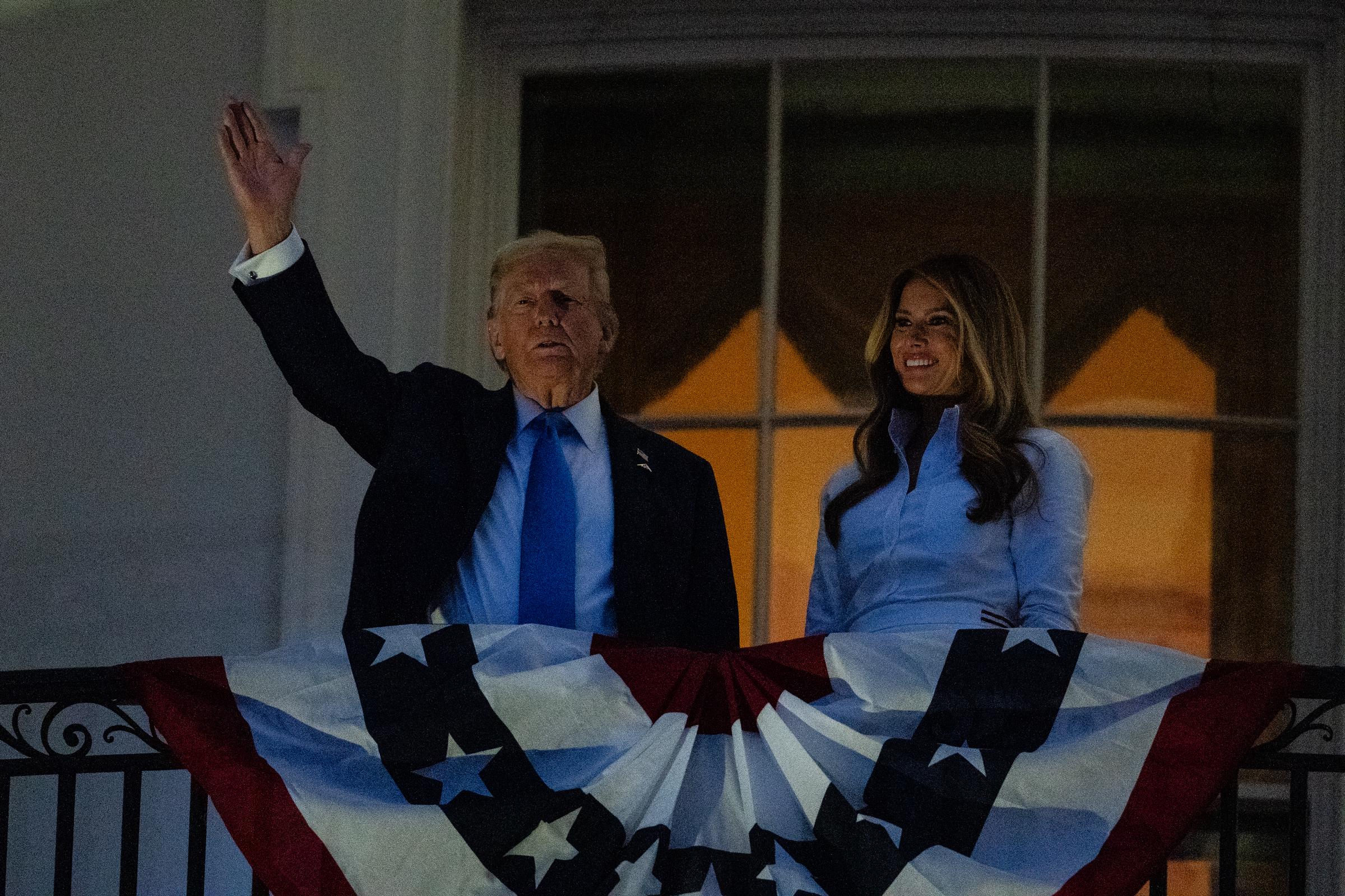 Donald Trump waves to the crowd as he and Melania Trump watch fireworks during a Fourth of July celebration at the White House on July 4, 2025 in Washington, DC. | Source: Getty Images