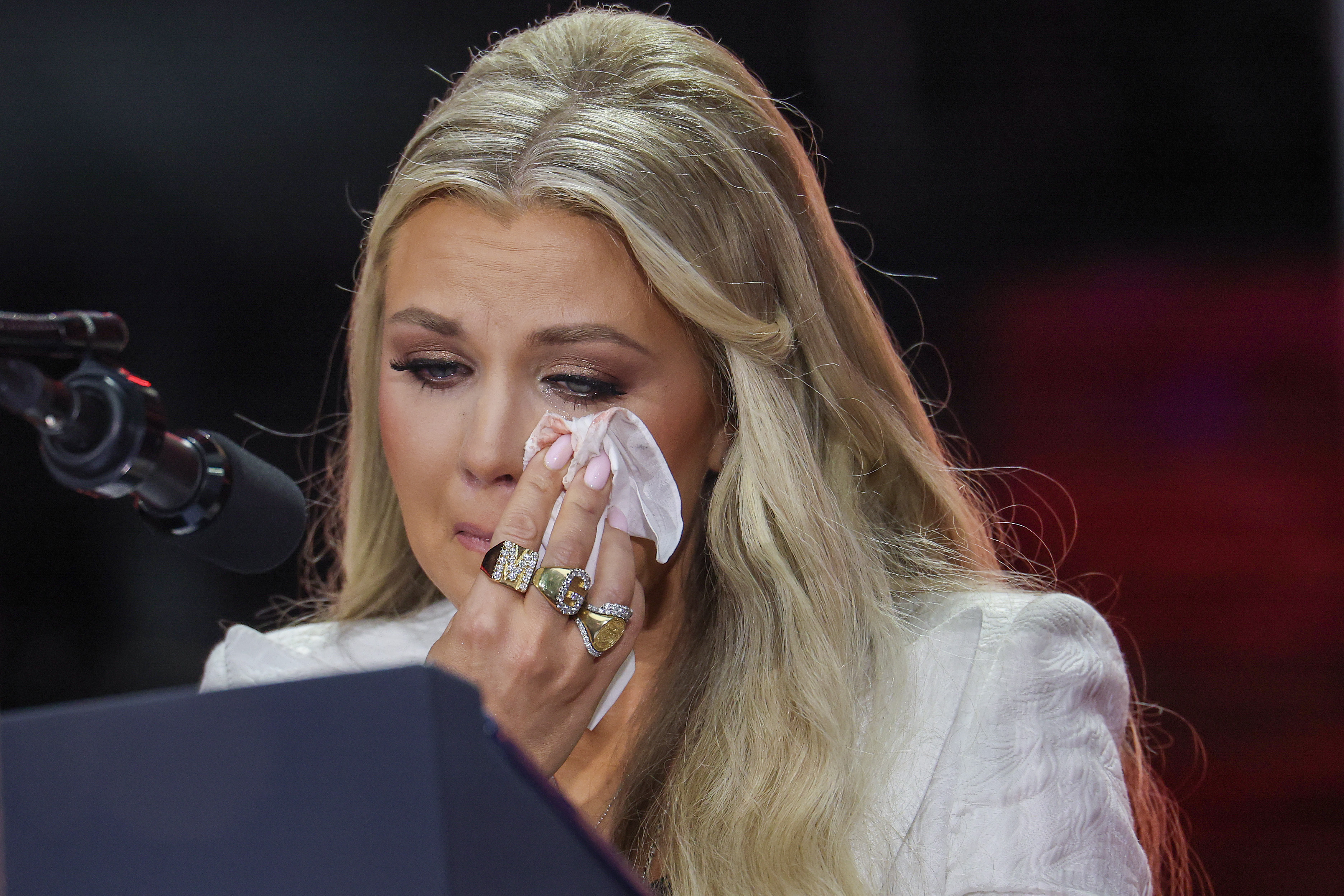 A tearful Erika Kirk looks on as she stands onstage. | Source: Getty Images