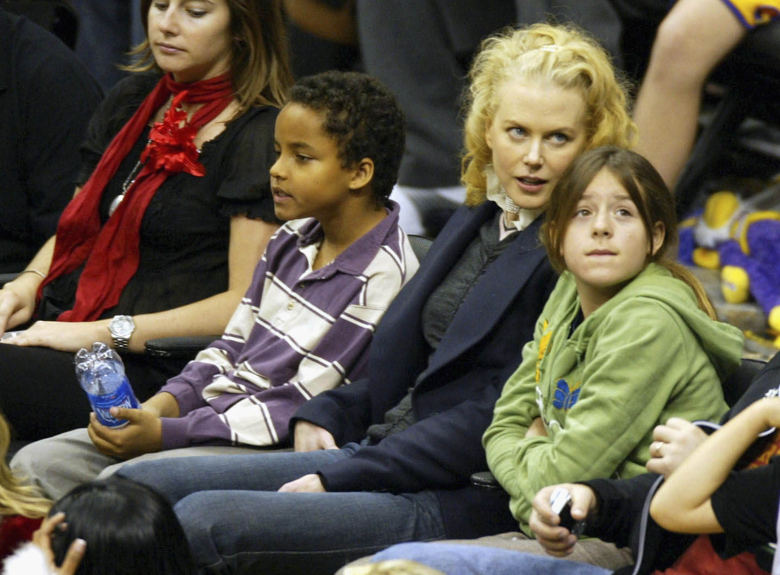 Nicole Kidman sits with her adopted children, Connor and Isabella Cruise, during a Los Angeles Lakers game in 2004. Years later, Kidman has remained protective of their relationship, saying, “I have to protect all those relationships” and that her children remain her purpose. | Source: Getty Images