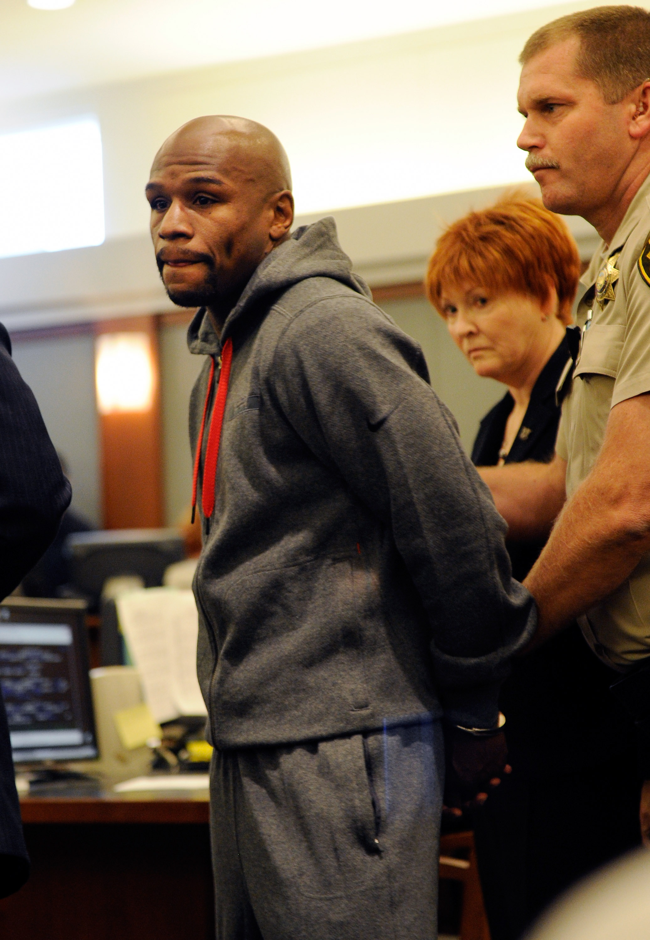 Floyd Mayweather Jr. is led away in handcuffs at the Clark County Regional Justice Center as he surrenders to serve a three-month jail sentence at the ÊClark County Detention CenterÊ on June 1, 2012 | Source: Getty Images