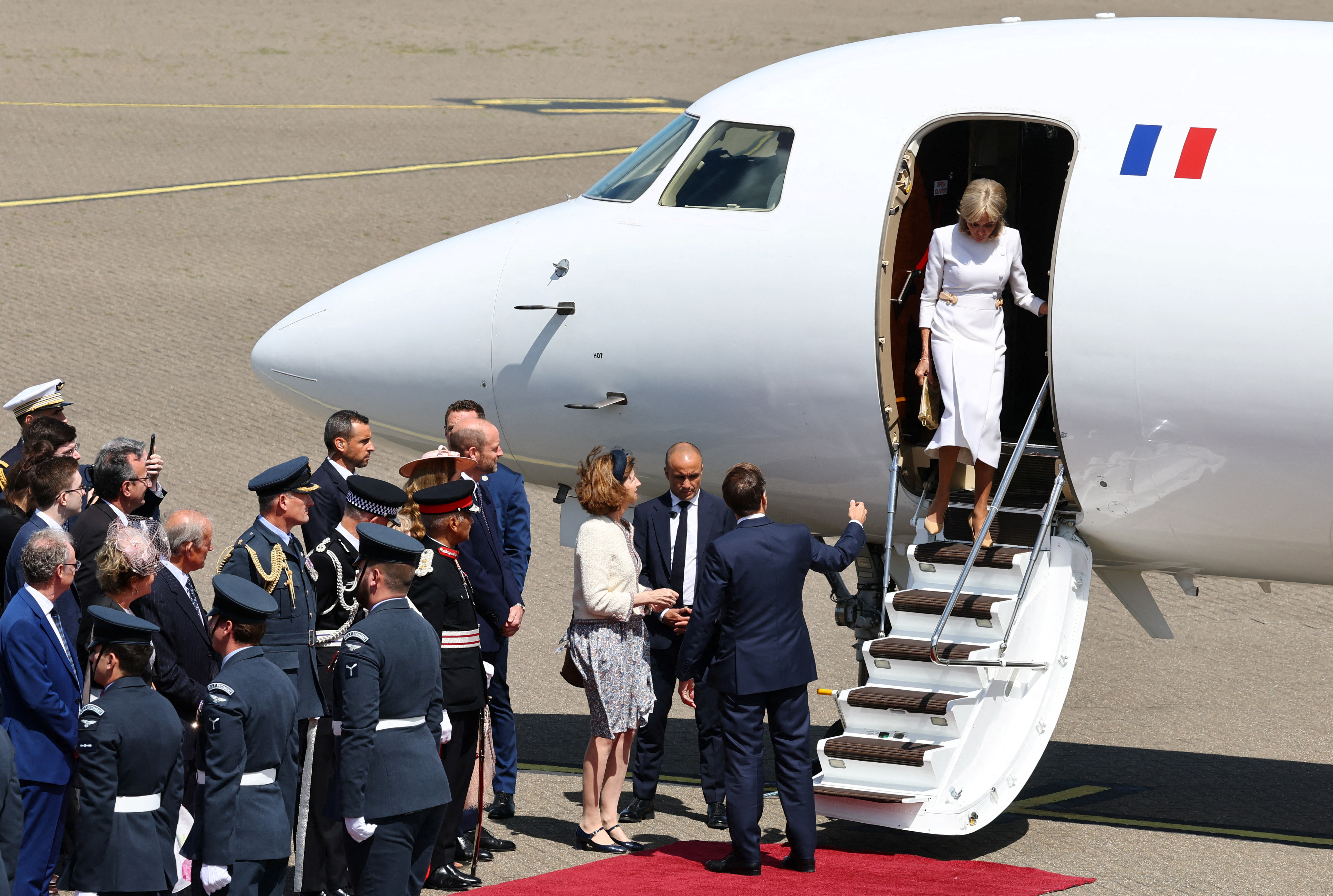 Brigitte is about to descend the aircraft stairs as she and her husband Emmanuel Macron arrive in Britain on July 8, 2025 | Source: Getty Images