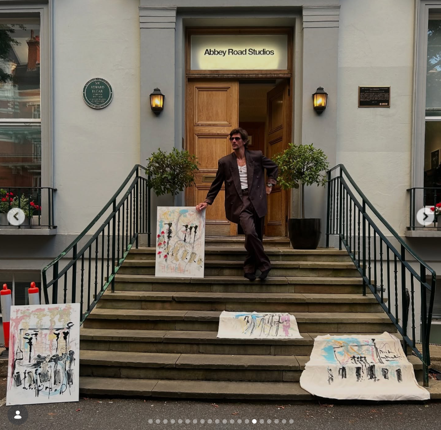 Jake Hall poses outside Abbey Road Studios alongside several of his original artworks. | Source: Instagram/jakehall