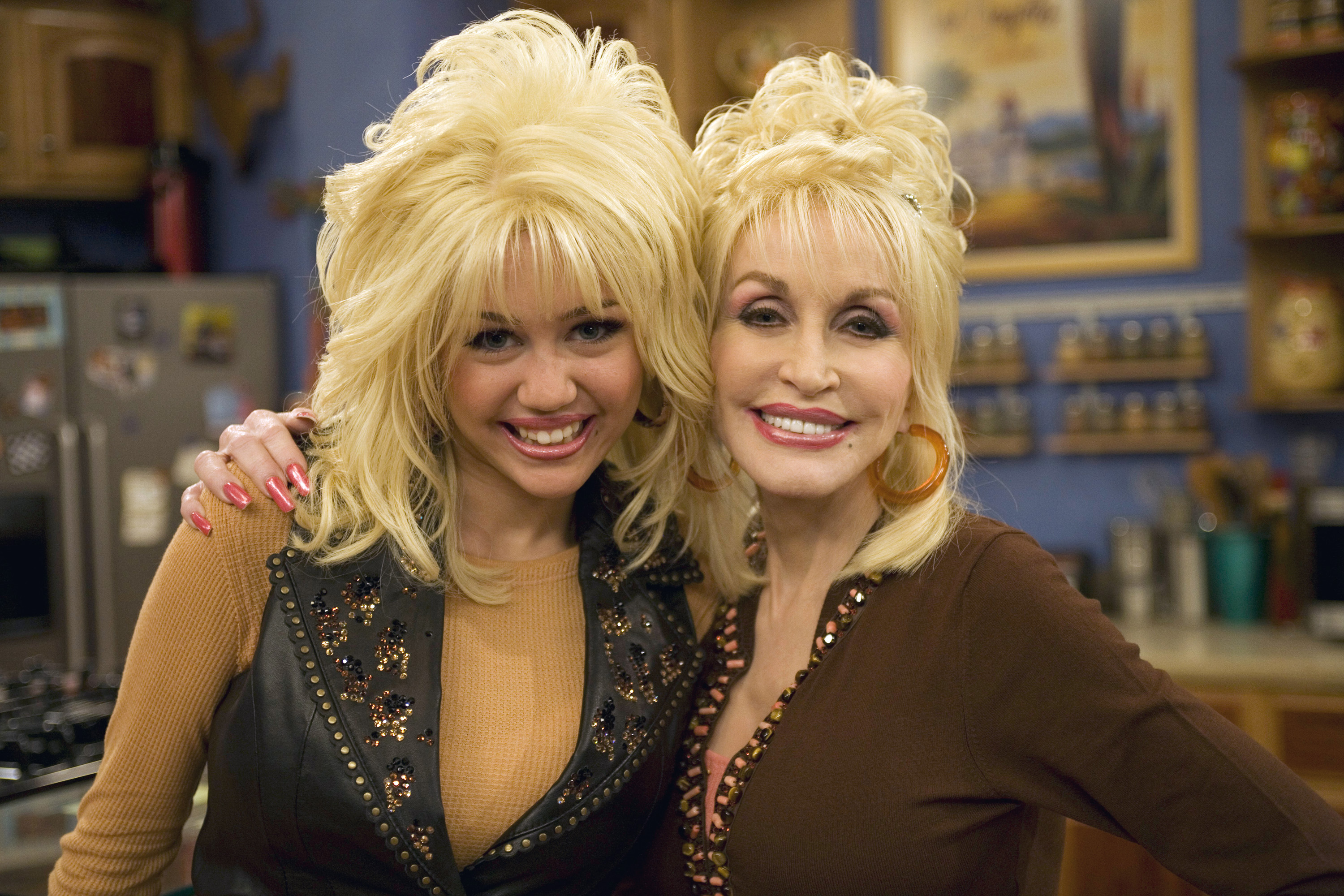 Miley Cyrus and Dolly Parton pose together in 2007, capturing the close bond between the singer and her famous godmother years before Parton's death.