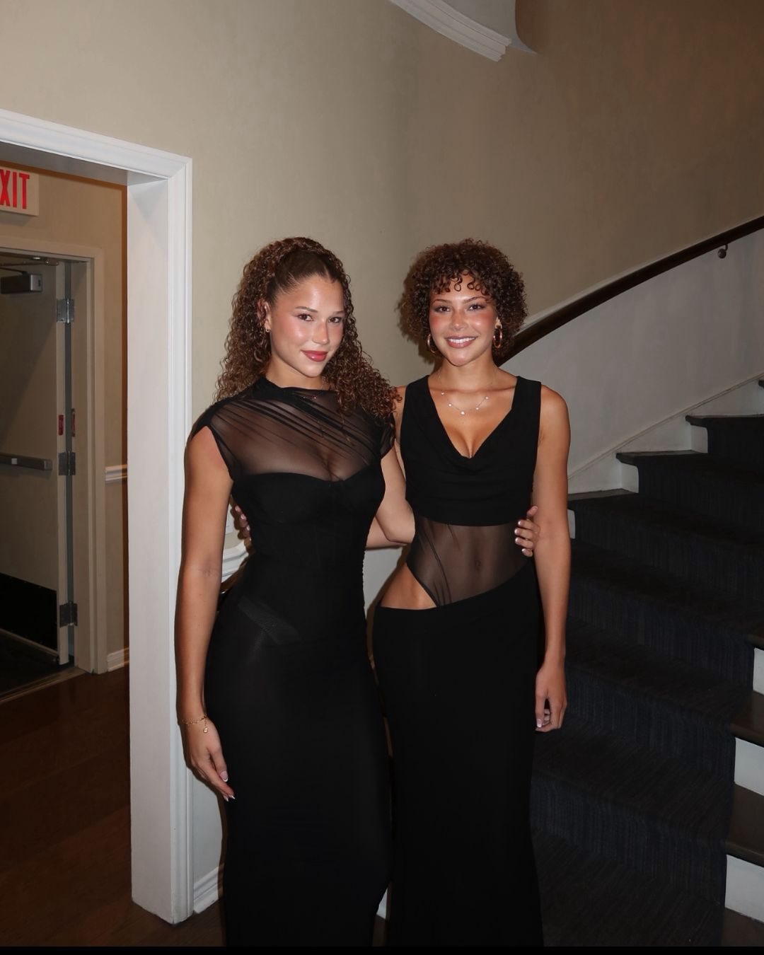 The sisters strike a glamorous pose in coordinating black ensembles, with their contrasting hairstyles highlighting Isabella's transformation after cancer treatment. | Source: Instagram/michaelstrahan