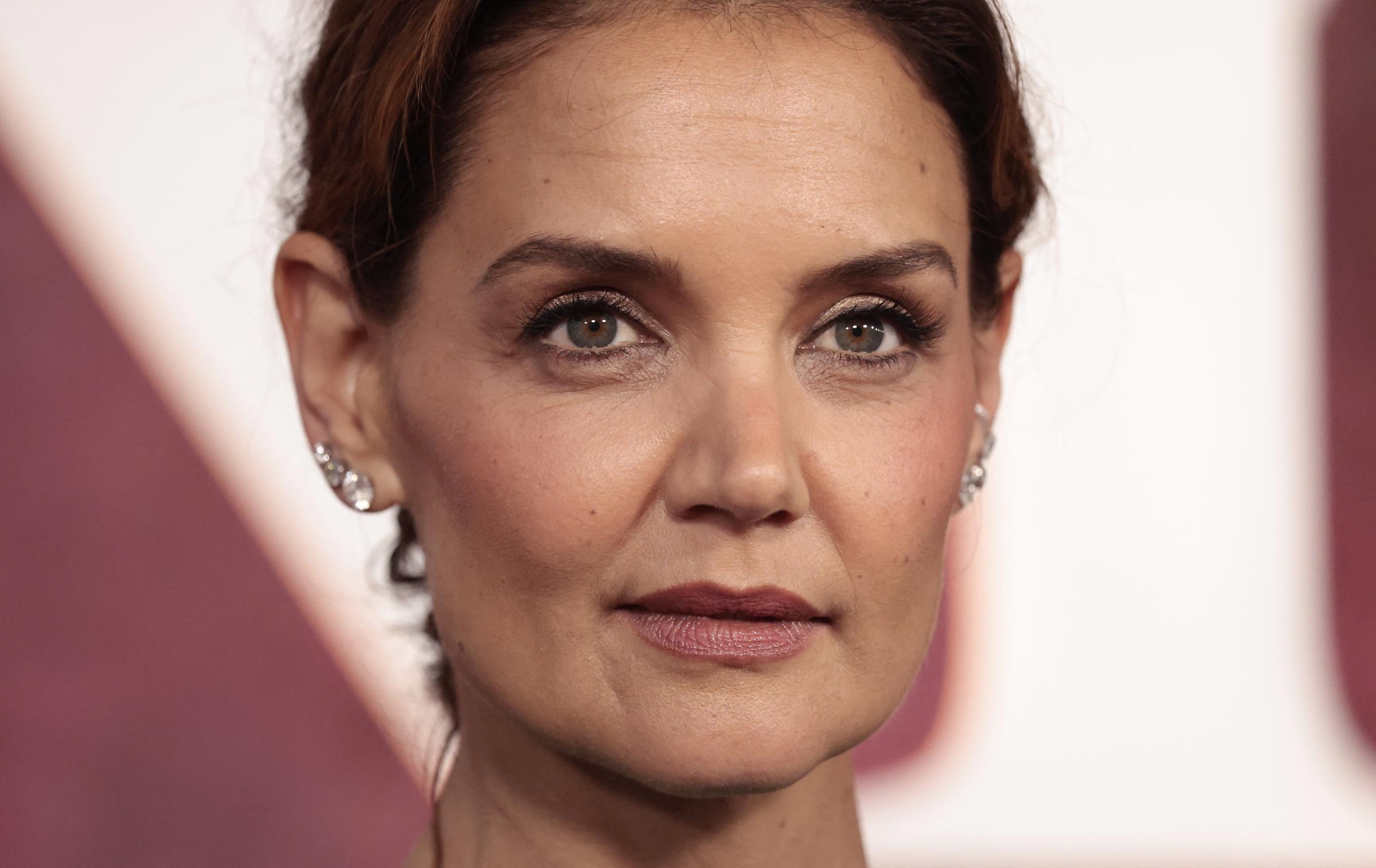 Katie Holmes attends the 78th Annual Tony Awards in New York City wearing a vivid green satin top with crystal earrings and soft glam makeup, posing confidently at Radio City Music Hall on June 8, 2025.