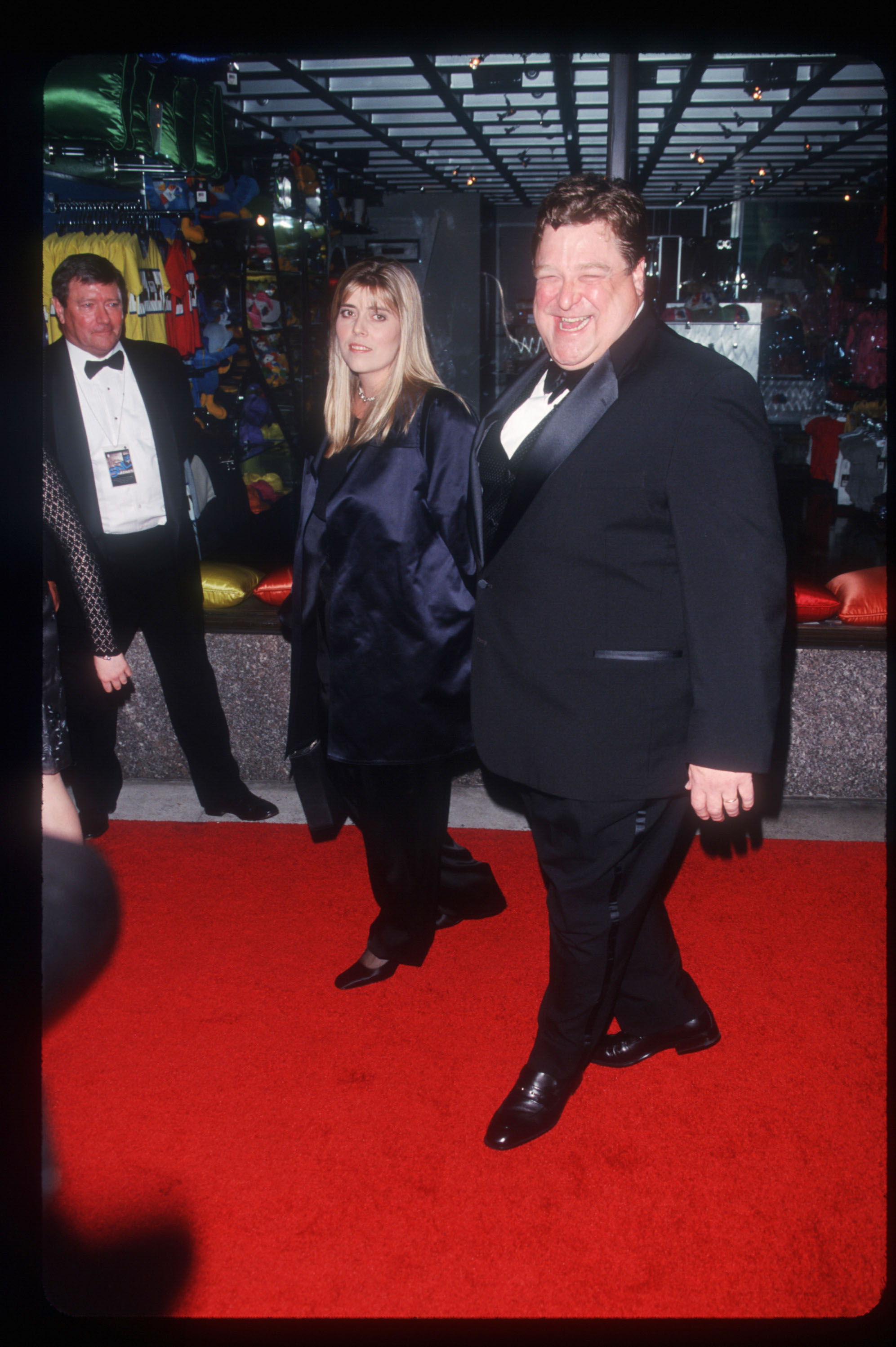 Celebrating the 25th anniversary of the hit comedy show "Saturday Night Live," Goodman was photographed in a chic-looking suit. He was caught on camera laughing, with an unidentified woman by his side at the September 26, 1999 event at NBC Studios in New York City.