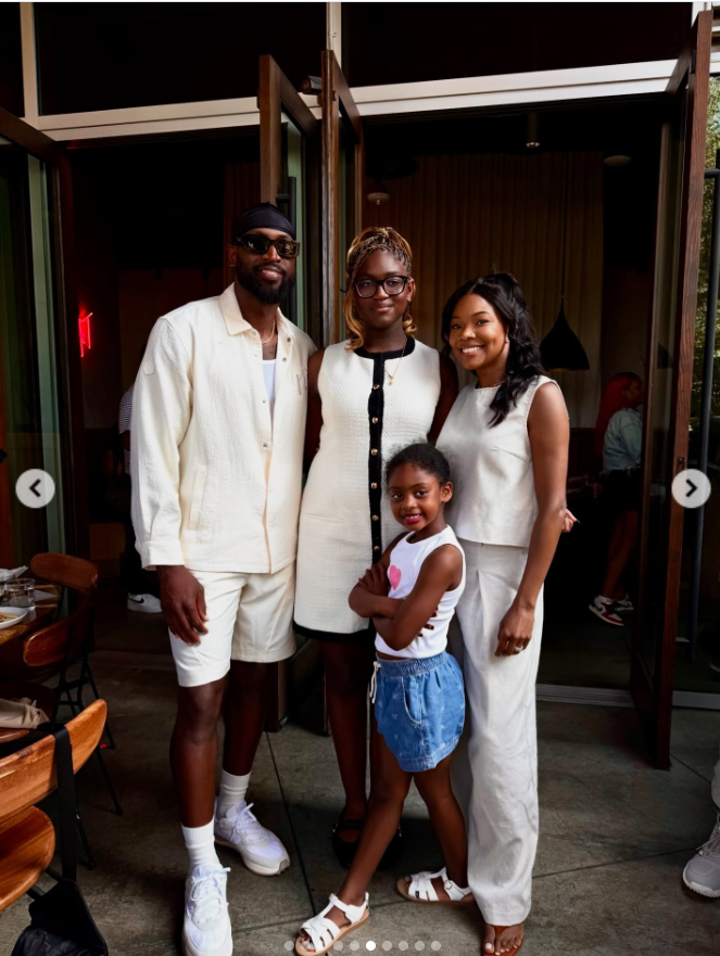Gabrielle Union and Dwyane Wade pose with two of their children at what appears to be a restaurant or event entrance. | Source: Instagram/gabunion