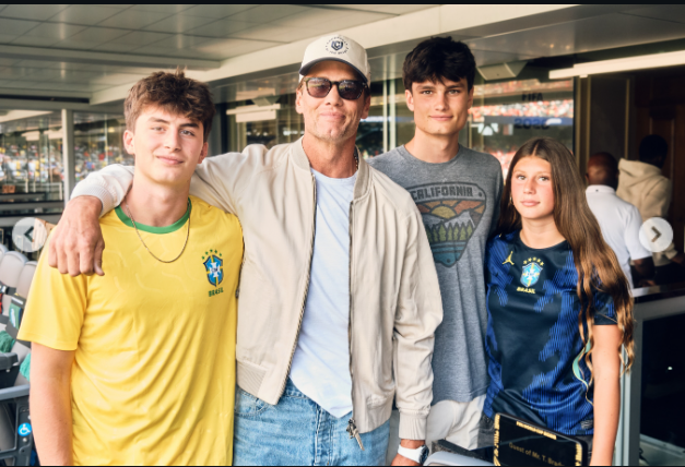 Tom Brady poses with his three children during a football event, sharing a family moment away from the spotlight of his professional career. The former NFL star has often offered glimpses of his life as a father, showing how family remains part of his world beyond sports. | Source: Instagram/tombrady