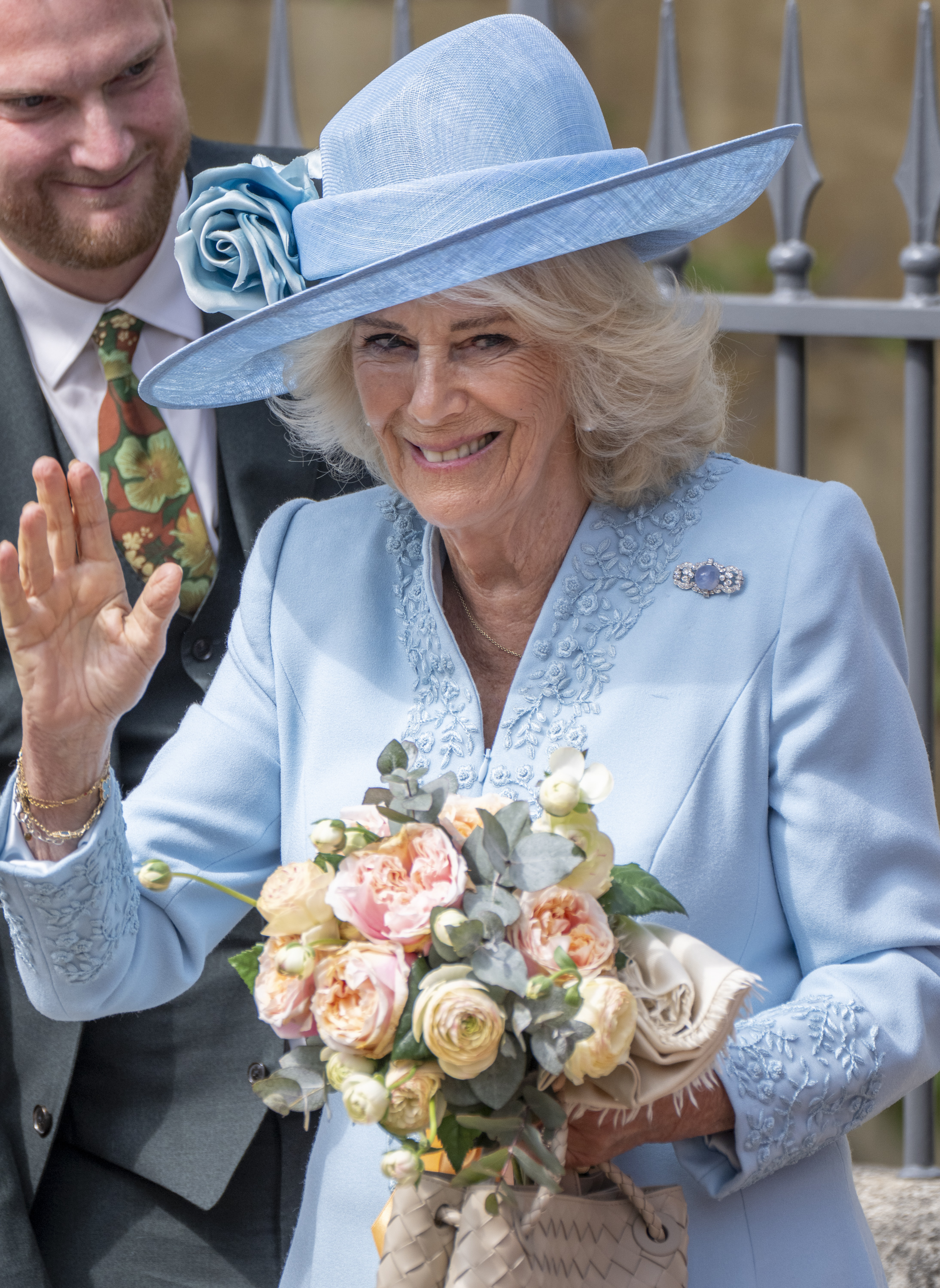 Queen Camilla waves as she departs from St George's Chapel in Windsor, England on April 20, 2025 | Source: Getty Images