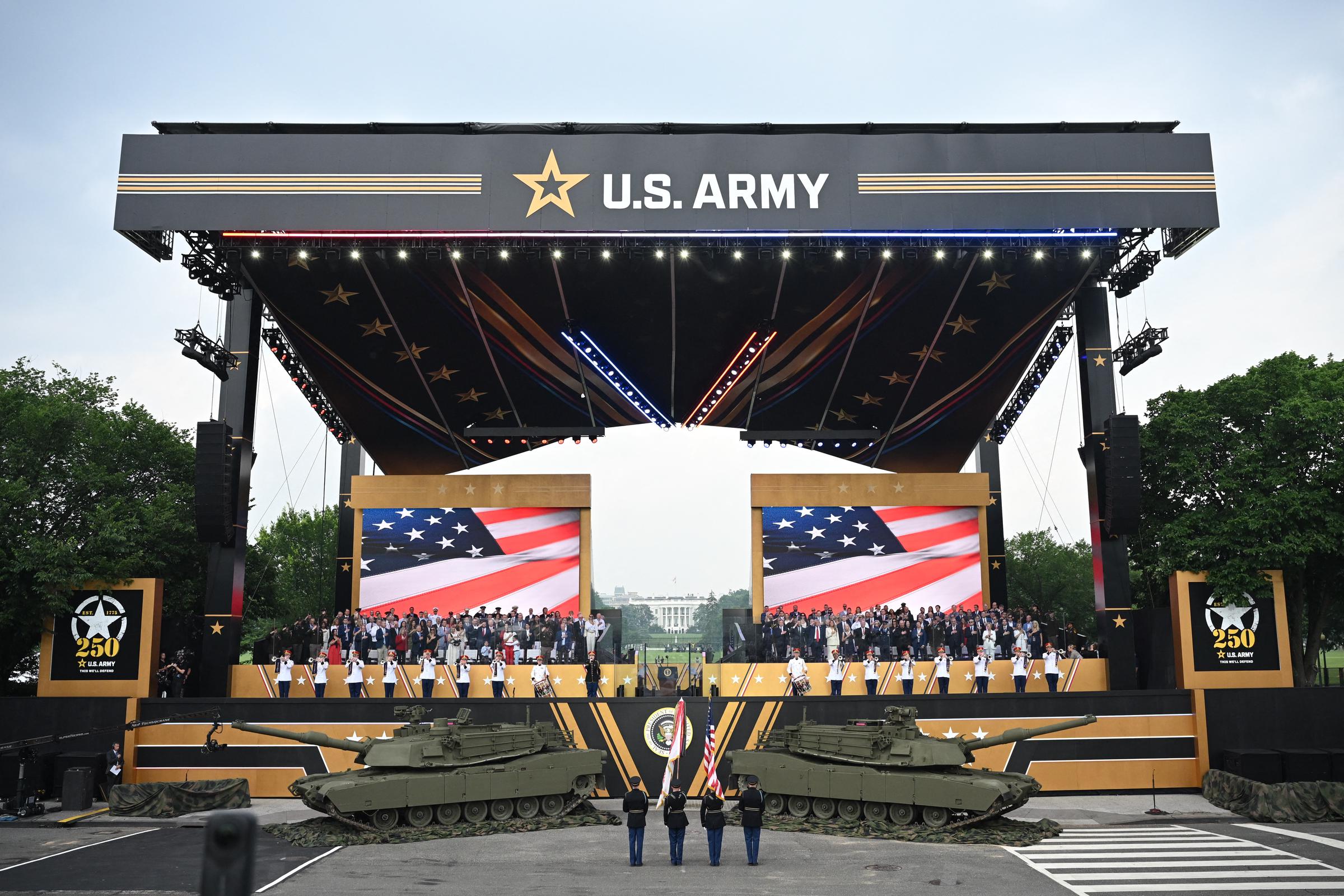 Donald and Melania Trump along with others gather on stage to watch the Army 250th Anniversary Parade on June 14, 2025 | Source: Getty Images