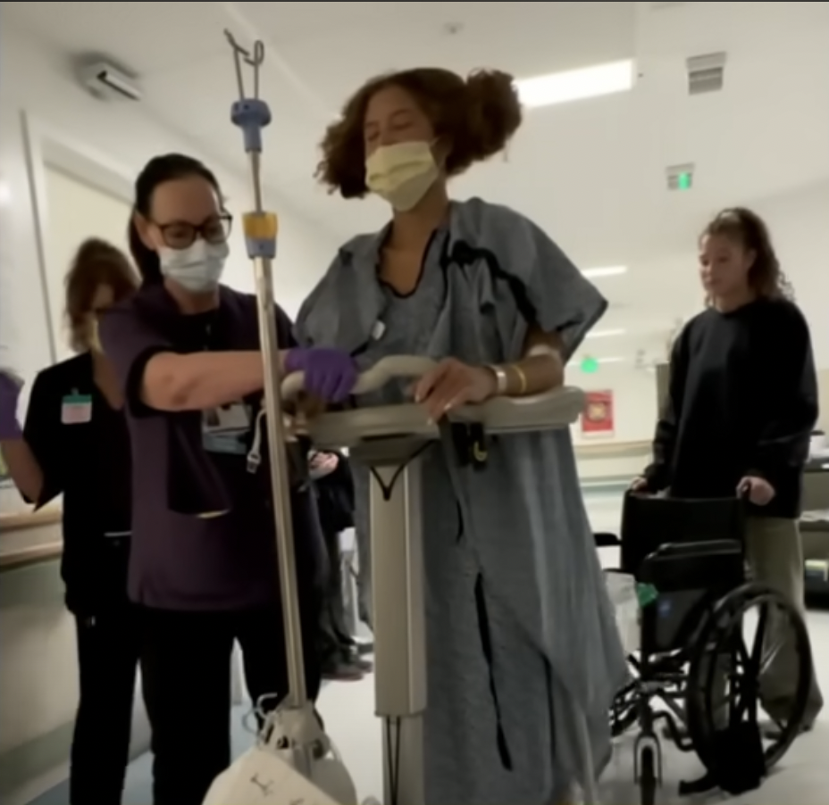 Isabella Strahan practices walking with medical assistance during her recovery in October 2023. | Source: YouTube/Good Morning America
