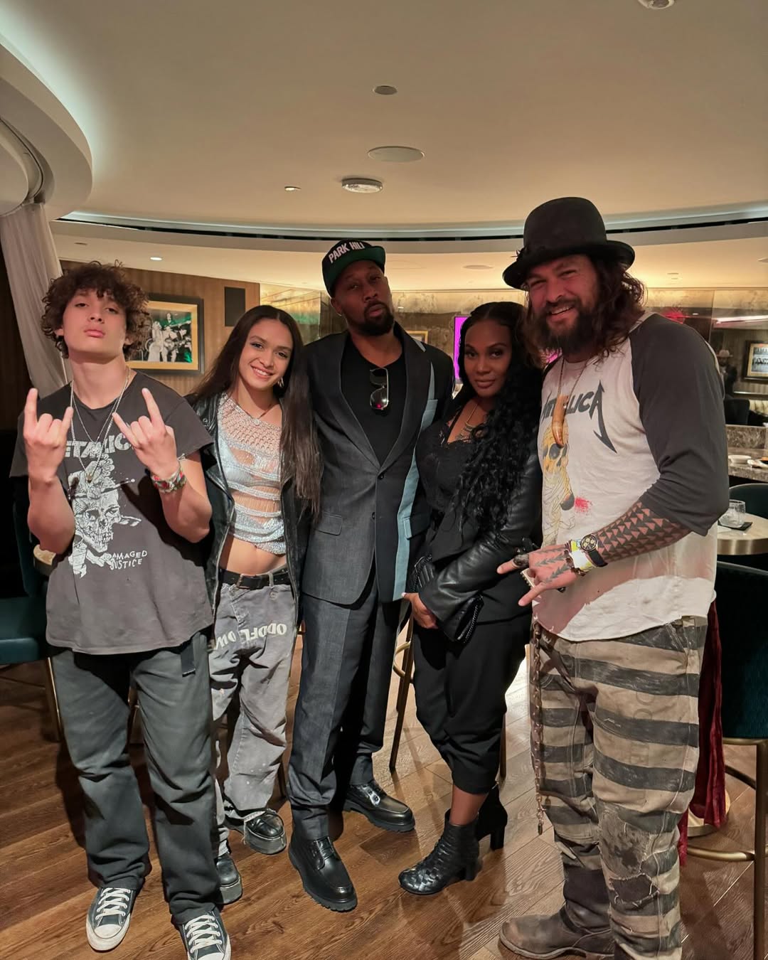 Nakoa-Wolf, Lola, and Jason Momoa posing with other celebs from a post dated December 14, 2024 | Source: Instagram/prideofgypsies