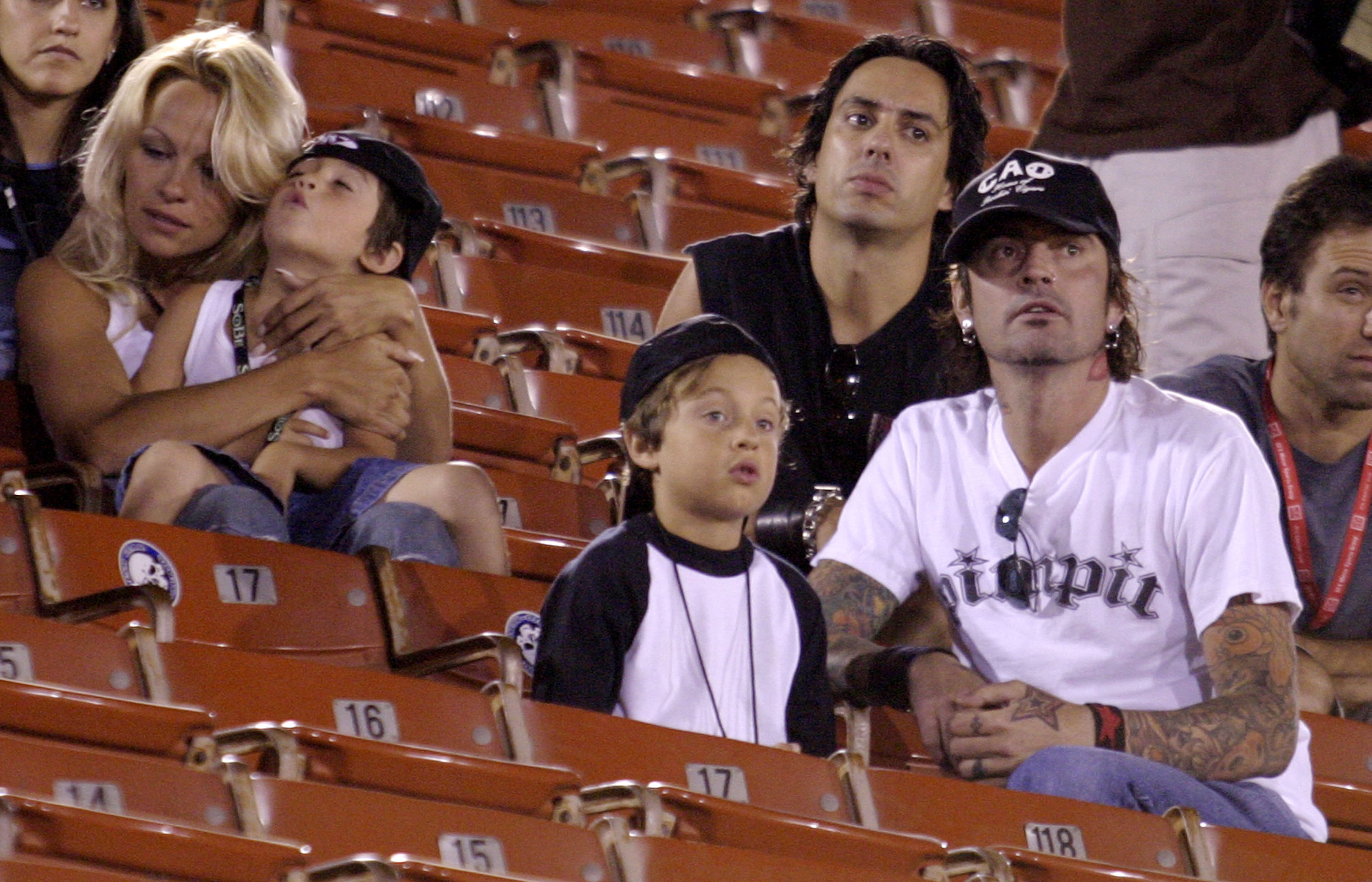 Pamela Anderson and Tommy Lee watched a game with their sons, Brandon and Dylan, during a family outing years after the former couple’s marriage ended. | Source: Getty Images